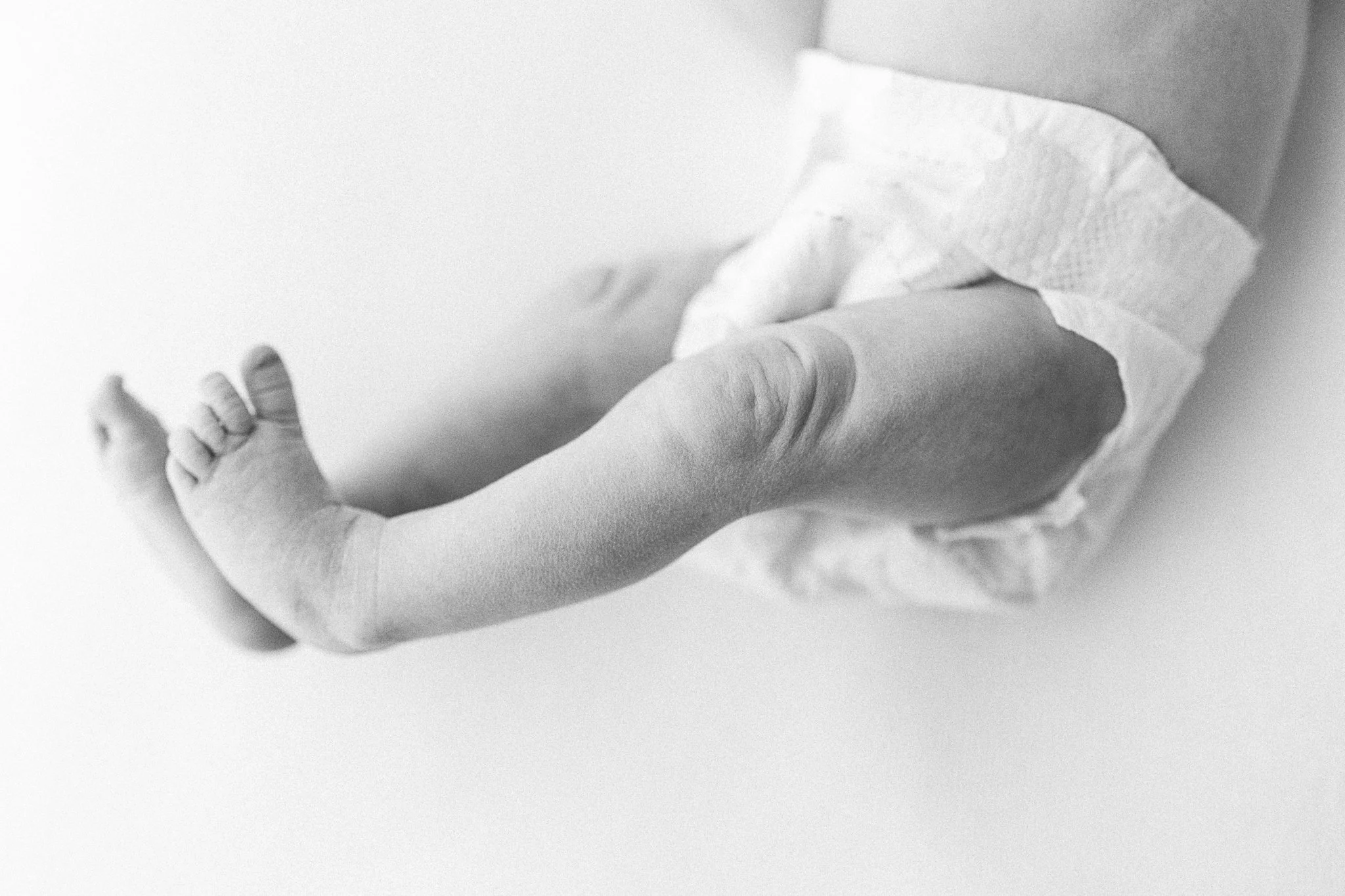 Detail shots: they are the little things that may not make it onto your wall in a frame, but capture the essence of your baby in a more subtle way.  These are always stunning in albums - they break up the faces shots and weave a deeper sense of your 