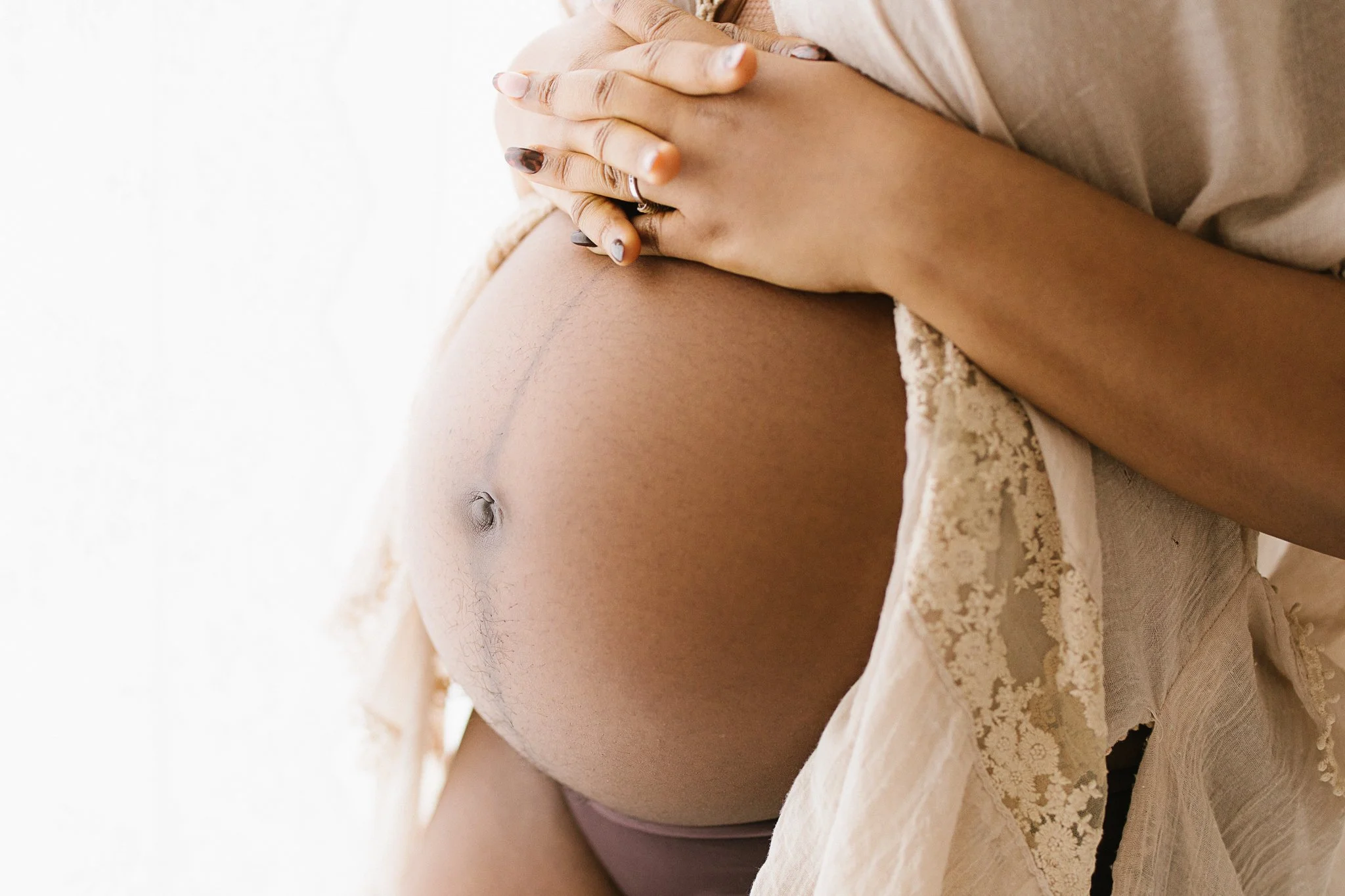close up maternity photography showing pregnant belly in natural light Cornwall