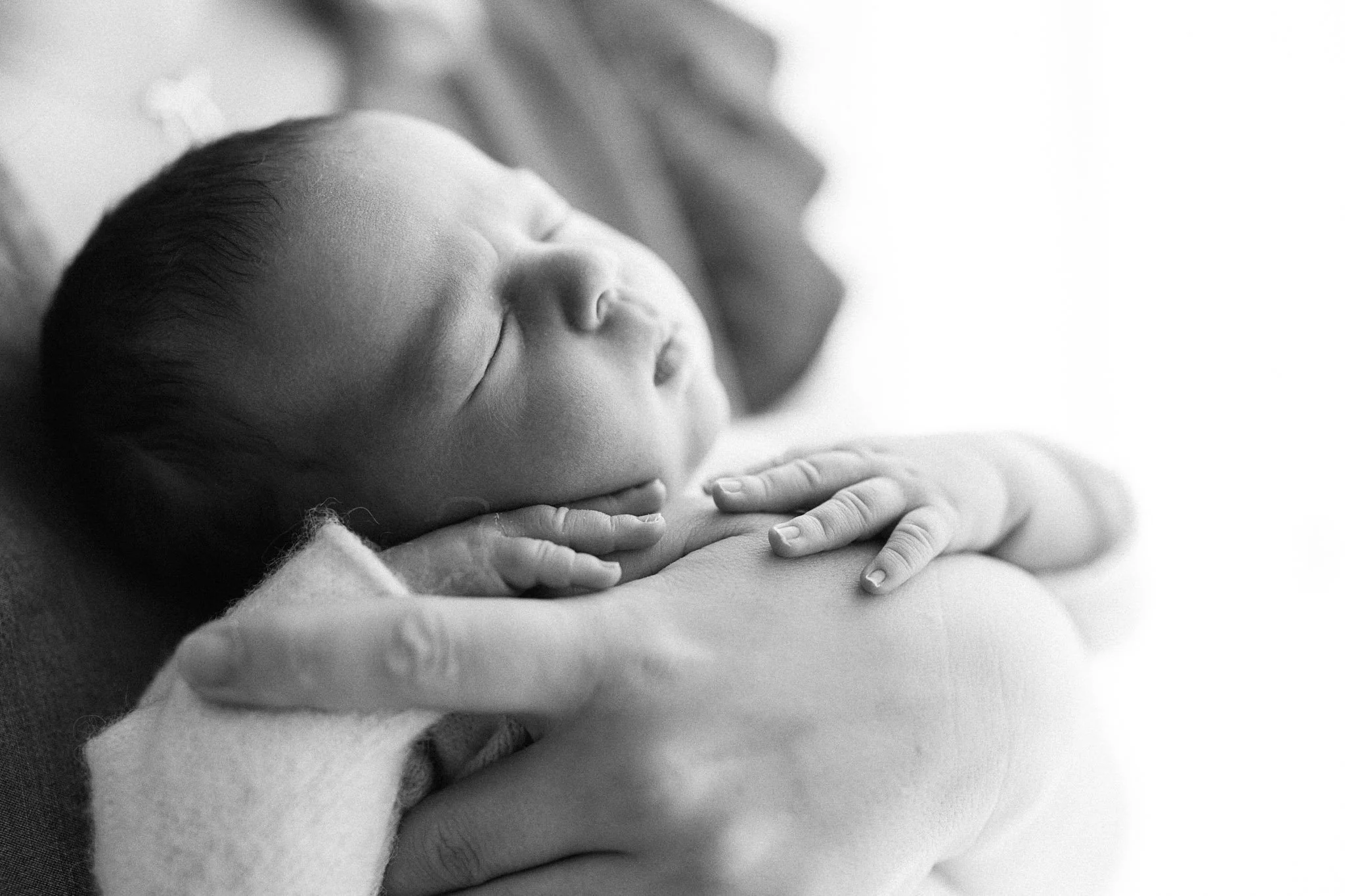 black and white photo of baby asleep during newborn photoshoot in Cornwall