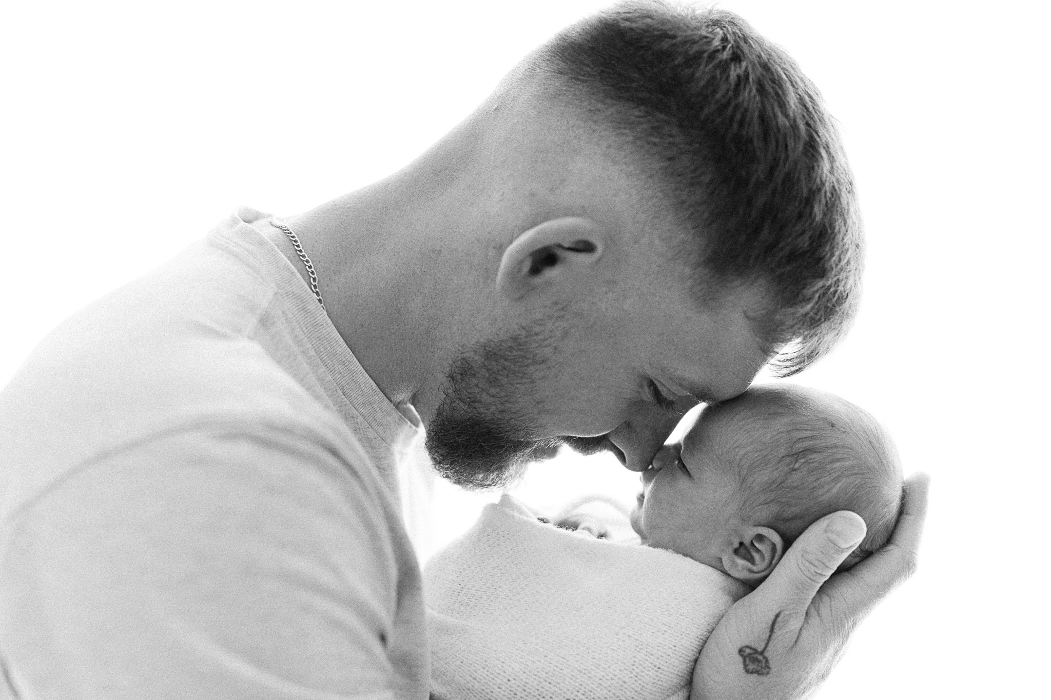 Intimate and soft father and baby moment during a newborn photoshoot in Cornwall