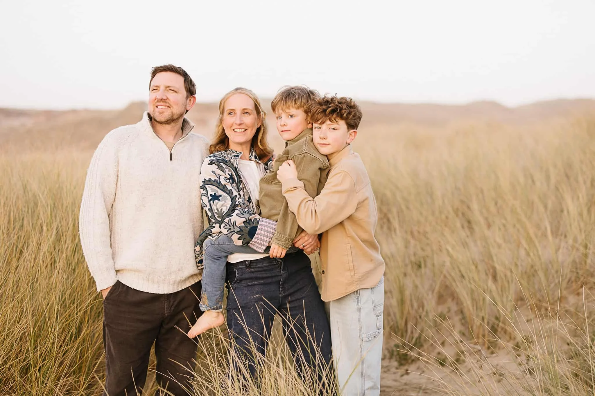 Relaxed moment during golden hour family photography session at Holywell Bay Beach Cornwall