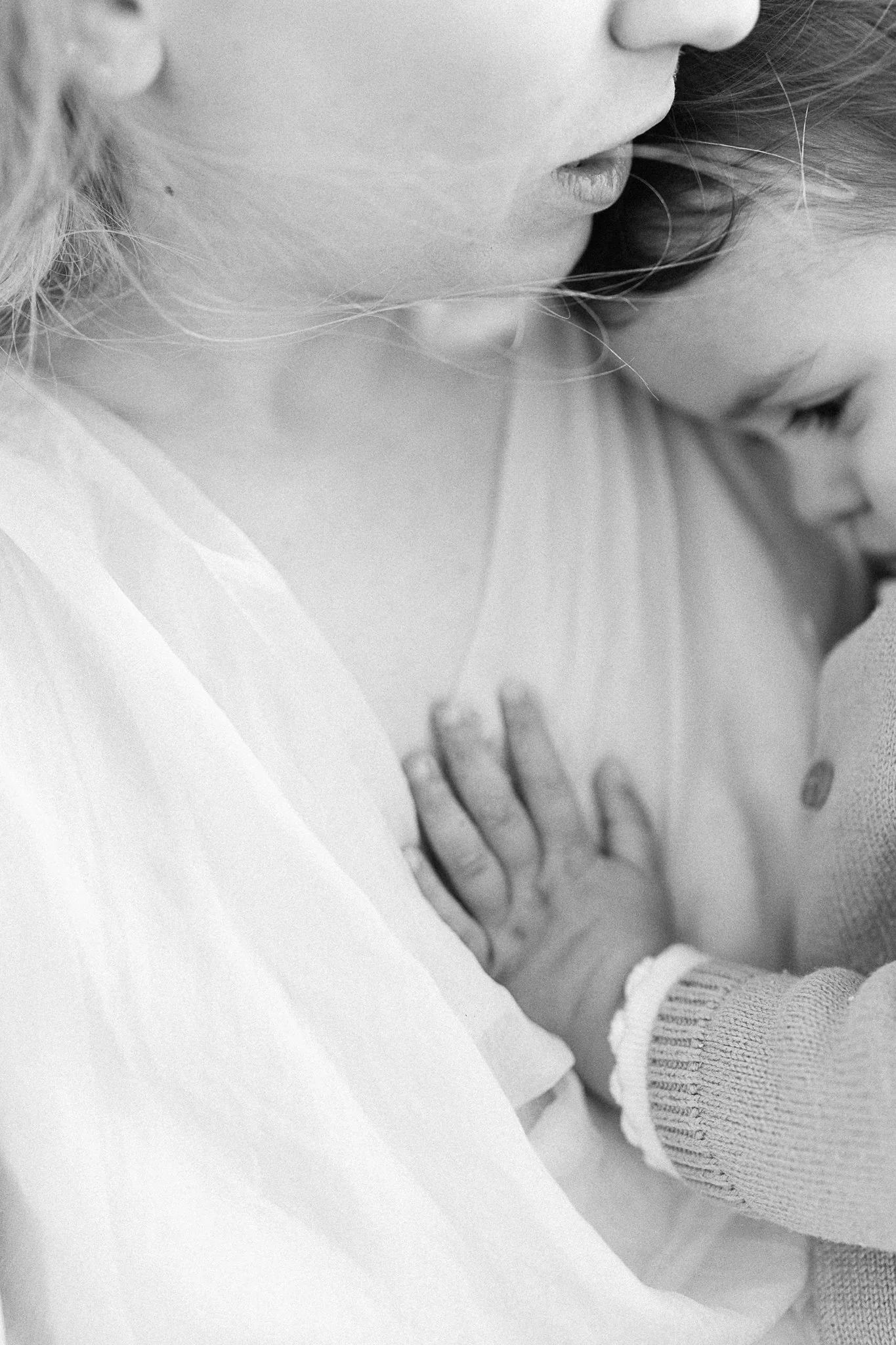 Baby resting on mum's chest during a family photoshoot in Cornwall
