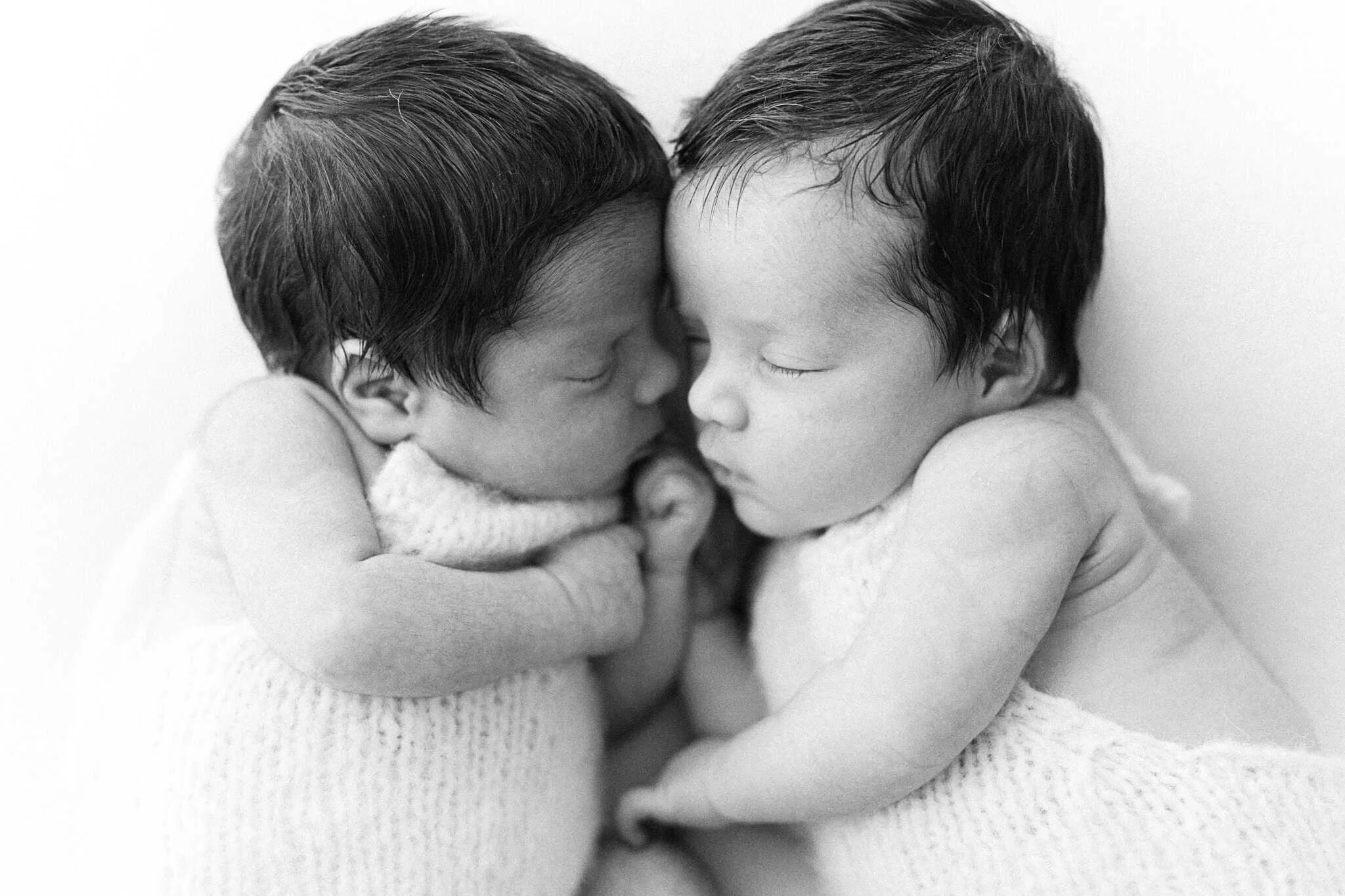 Twin newborns sleeping close together, black and white newborn photography Cornwall