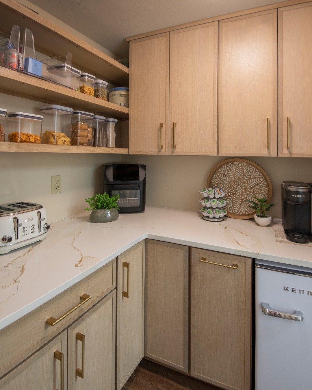We added this pantry right off the kitchen in this midcentury-modern home. Although the cabinetry is different, we tied the two spaces together by using the same countertop in both rooms.