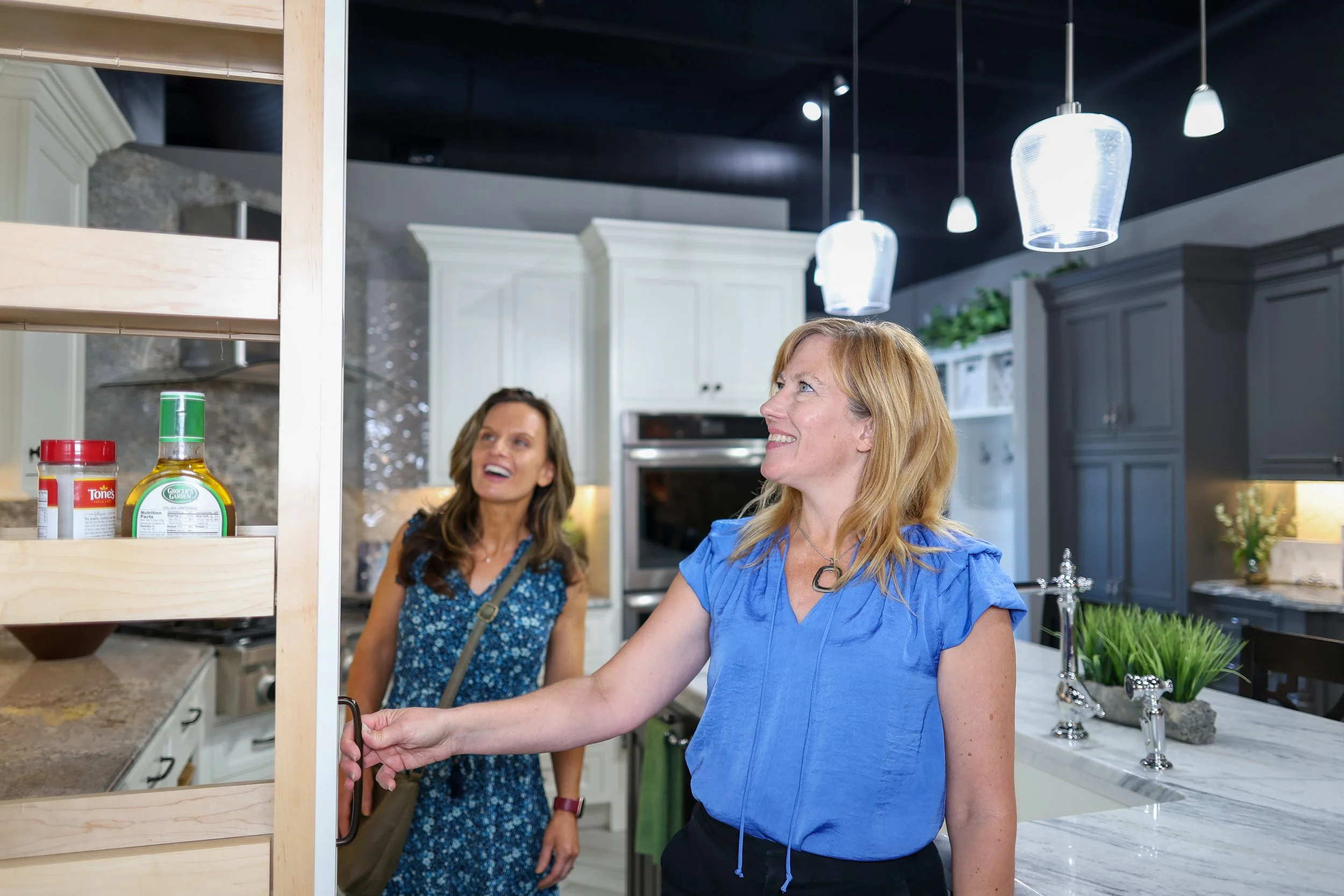 Two women, a client and a designer, in a kitchen cabinetry showroom