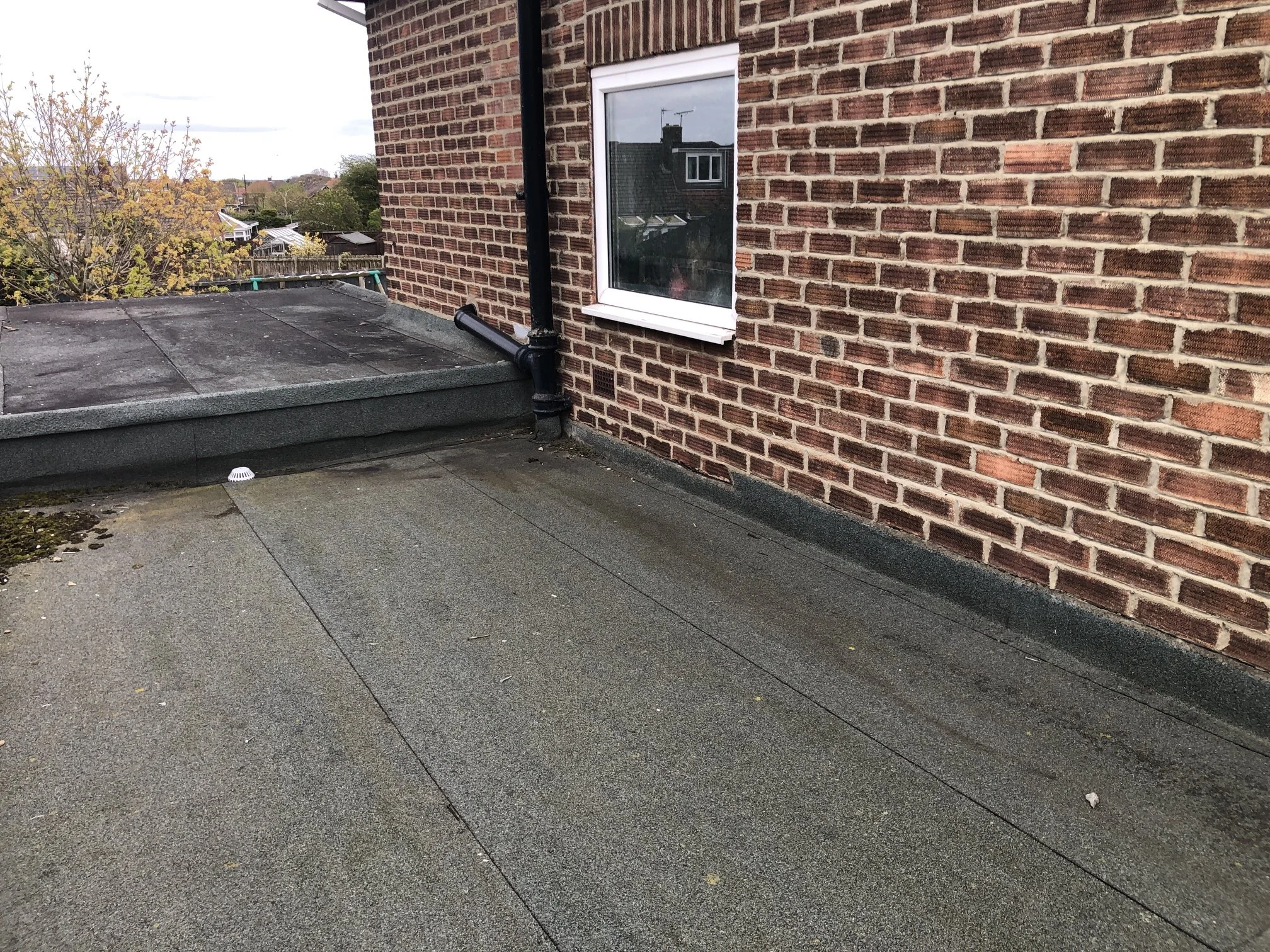 Garage flat roof in Newburn re-covered in EPDM rubber using the overlay method, showing the clean join to the neighbouring garage