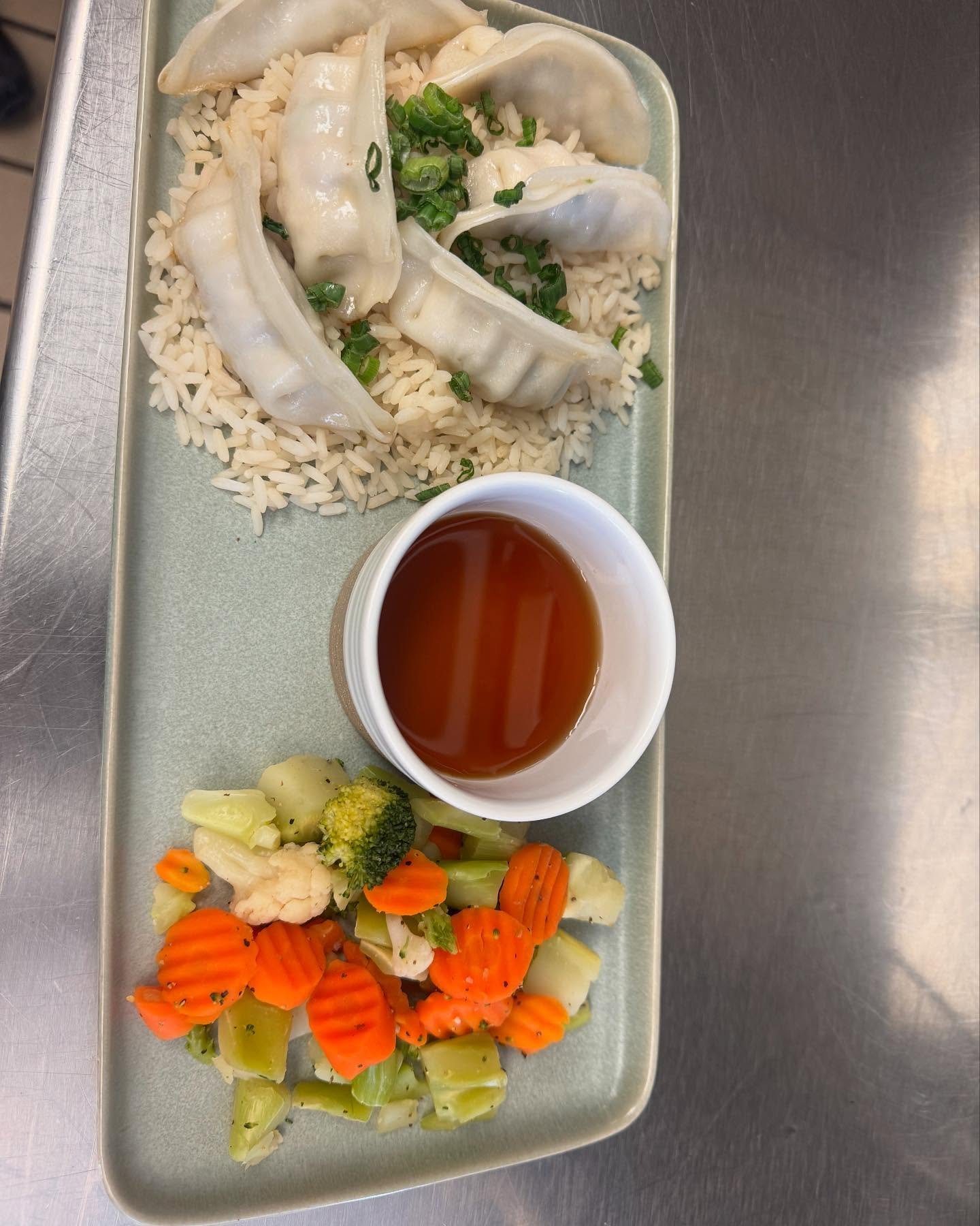 A wonderful gluten free option with potstickers, rice, veggies, and a ponzu sauce.