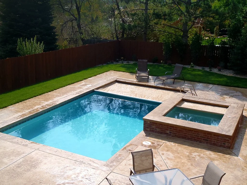Backyard with swimming pool, spa, and patio chairs
