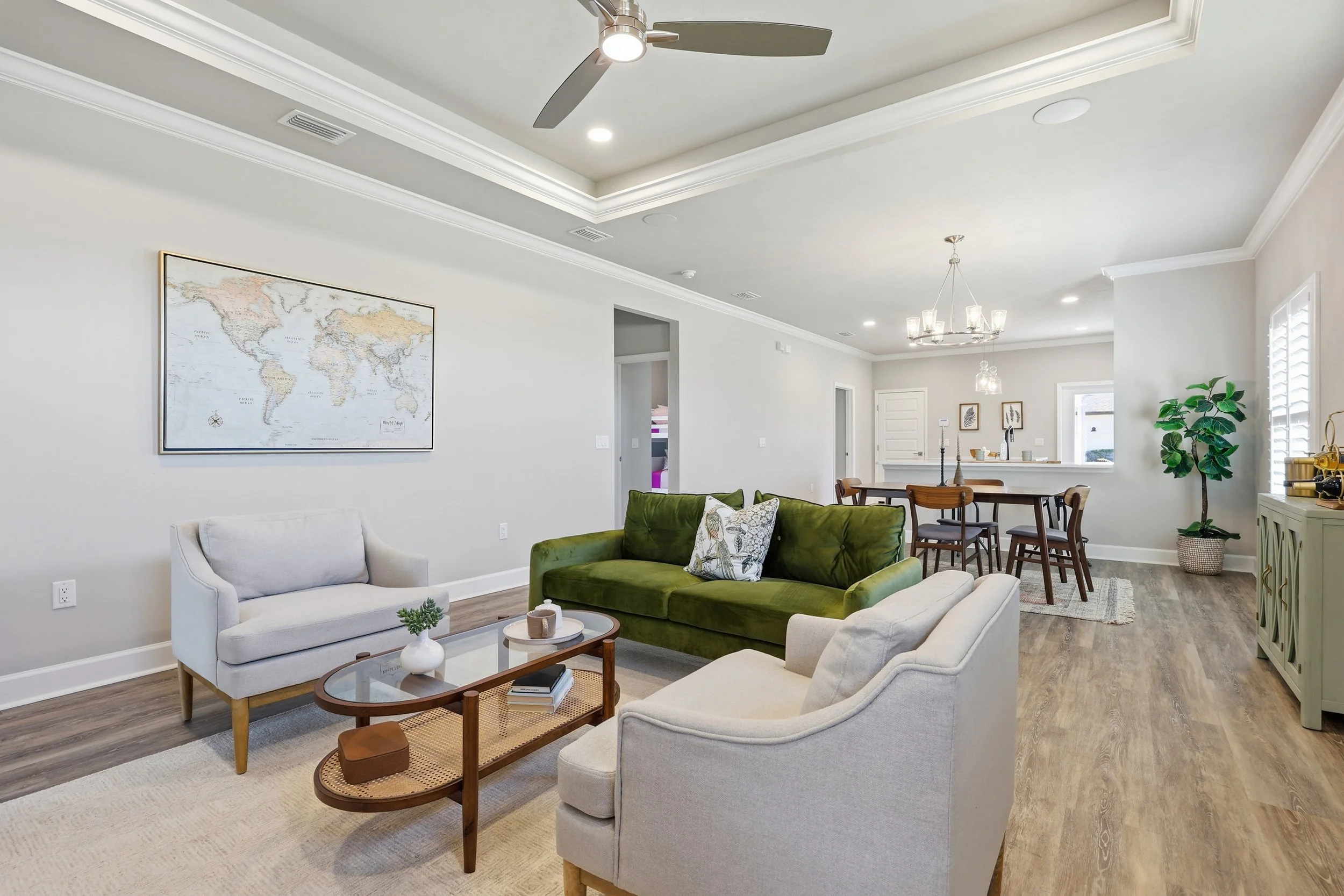 Living room, dining area and kitchen in the Sicily model home in Lugano, an Emmer Development Community