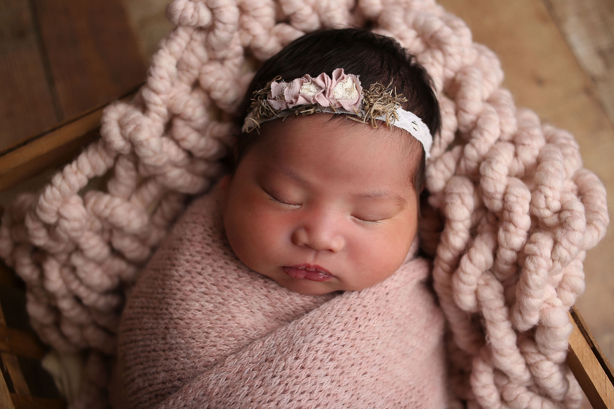  a beautiful newborn wrapped in a pink blanket 