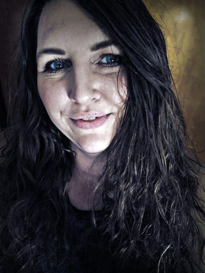 This is a photo of author Heather Miller. She has long, dark hair and is smiling at the camera.