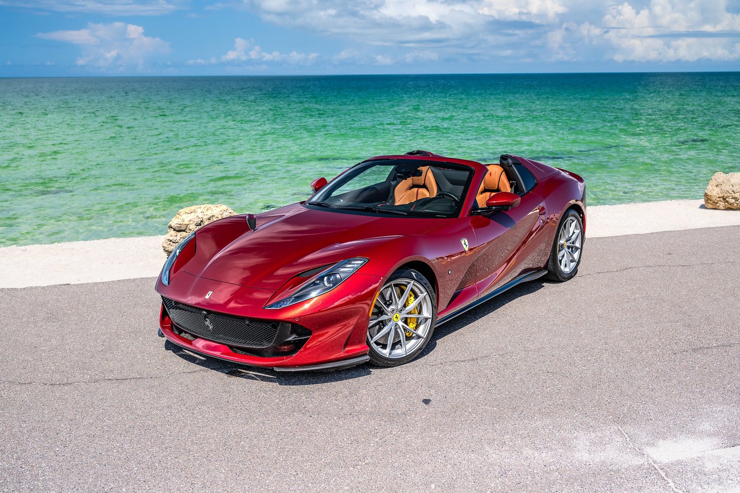 Red Ferrari convertible beside the coast