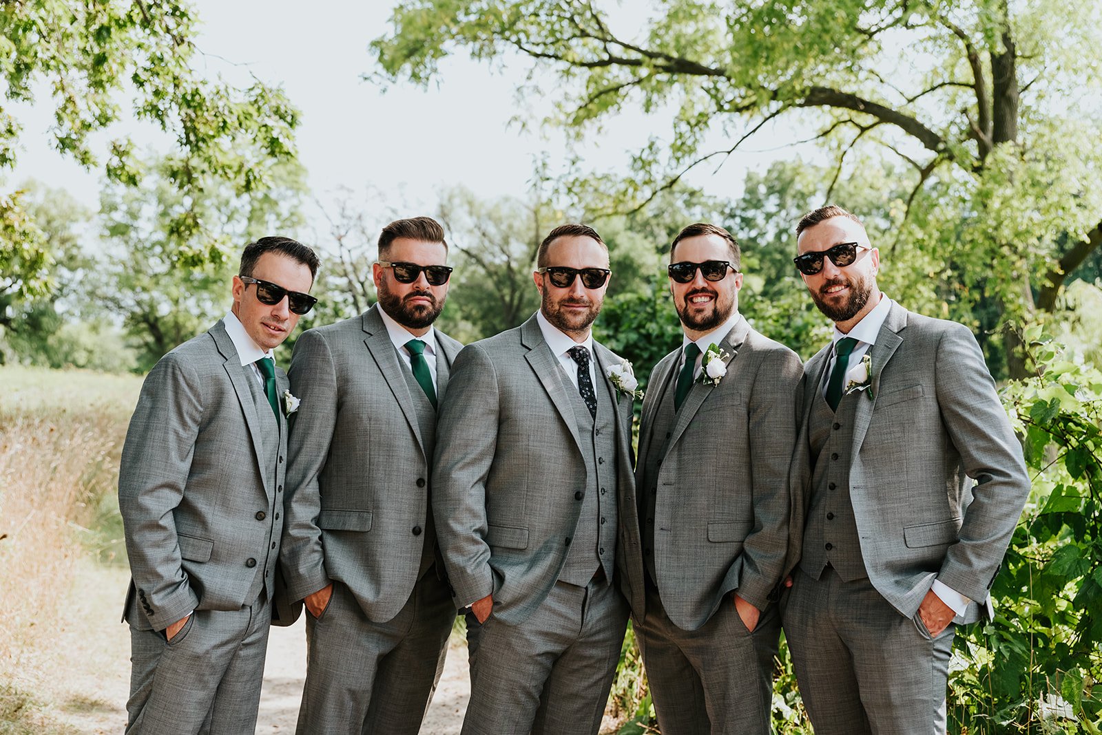 Groom poses with groomsmen in gray suits photo by Fedora Media.jpg
