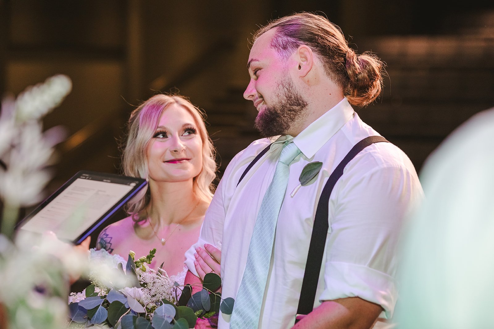 Bride and groom look with love at each other during wedding photo by Fedora Media