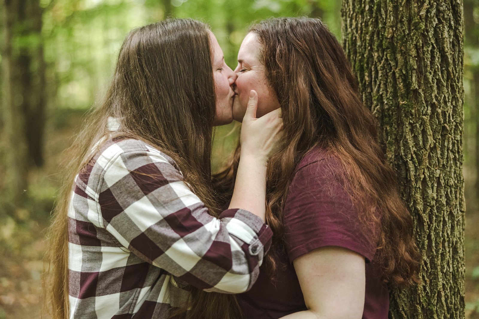 gay couple kisses in the woods at engagement photoshoot photo by Fedora Media.jpg