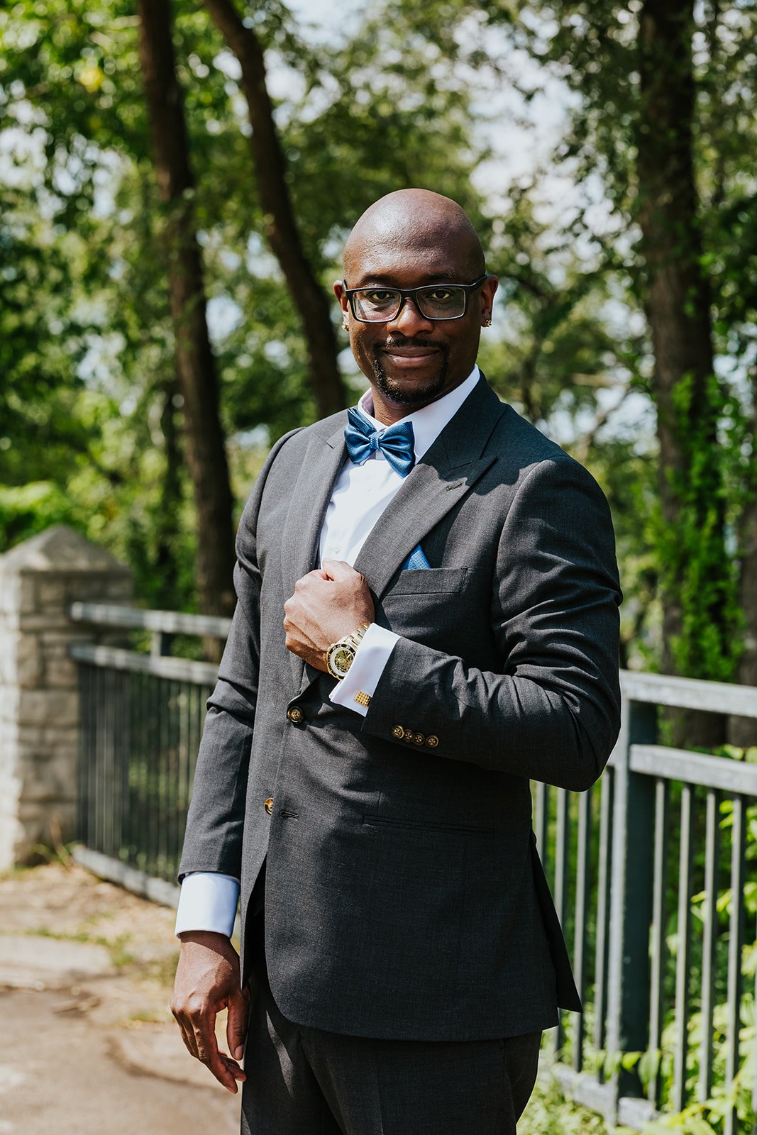 Groom in a black suit and blue bowtie photo by Fedora Media.jpg