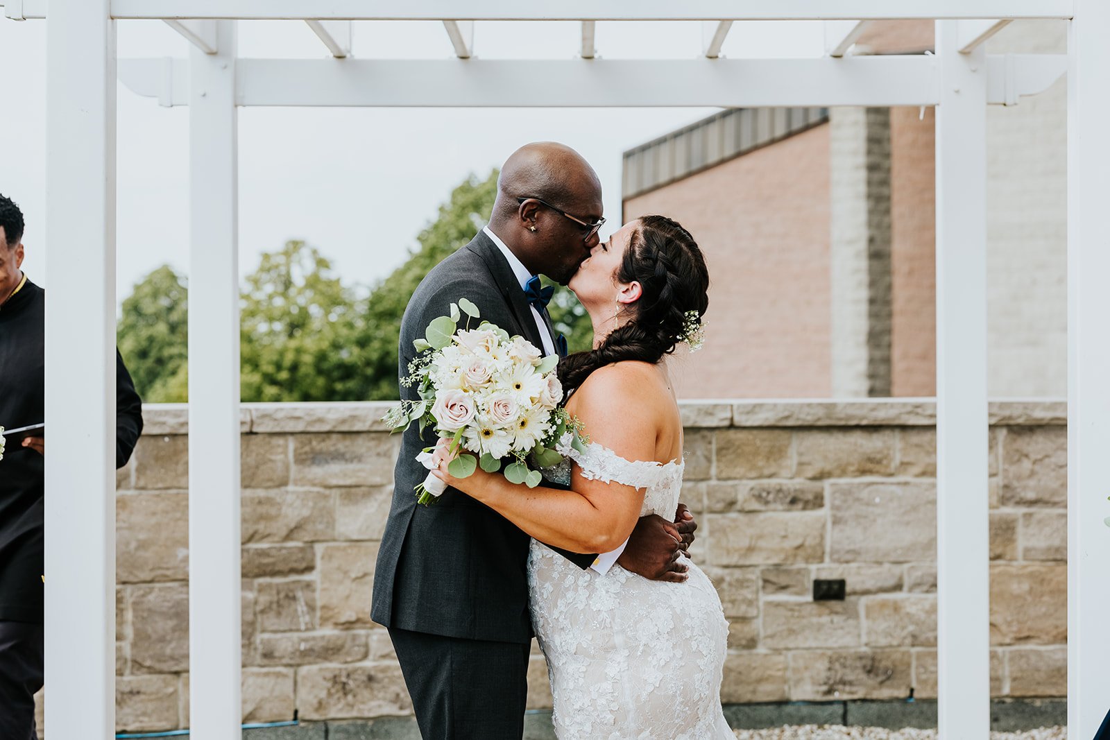 Bride and groom first kiss photo by Fedora Media.jpg