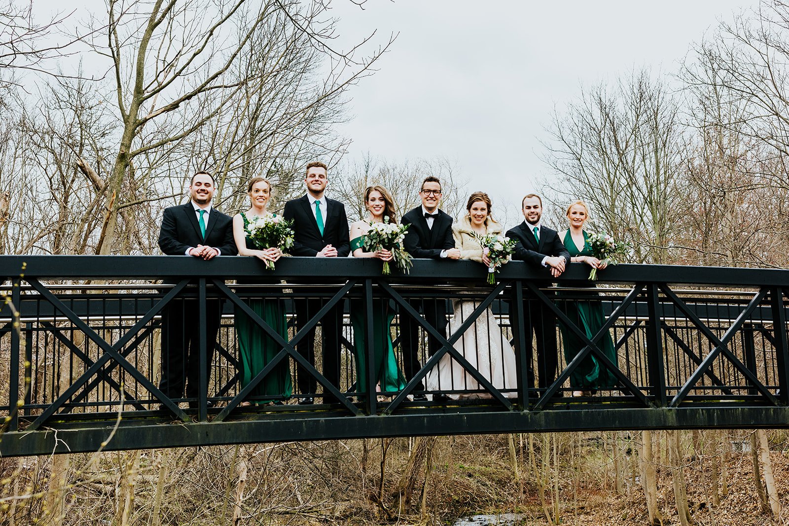 Bride, groom and wedding party on a bridge at Ancaster Mill photo by Fedora Media.jpg