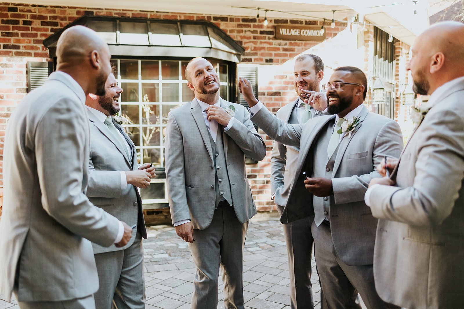 Candid photo of groom and groomsmen at Village Square Burlington photo by Fedora Media.jpg