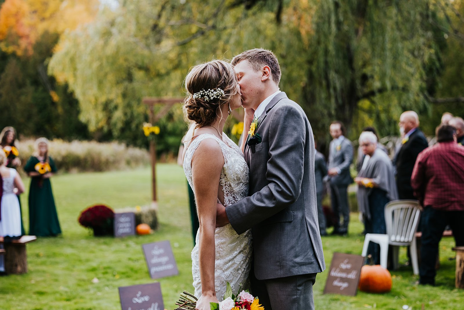 Bride and groom kiss at the end of the aisle after getting married photo by Fedora Media.jpg
