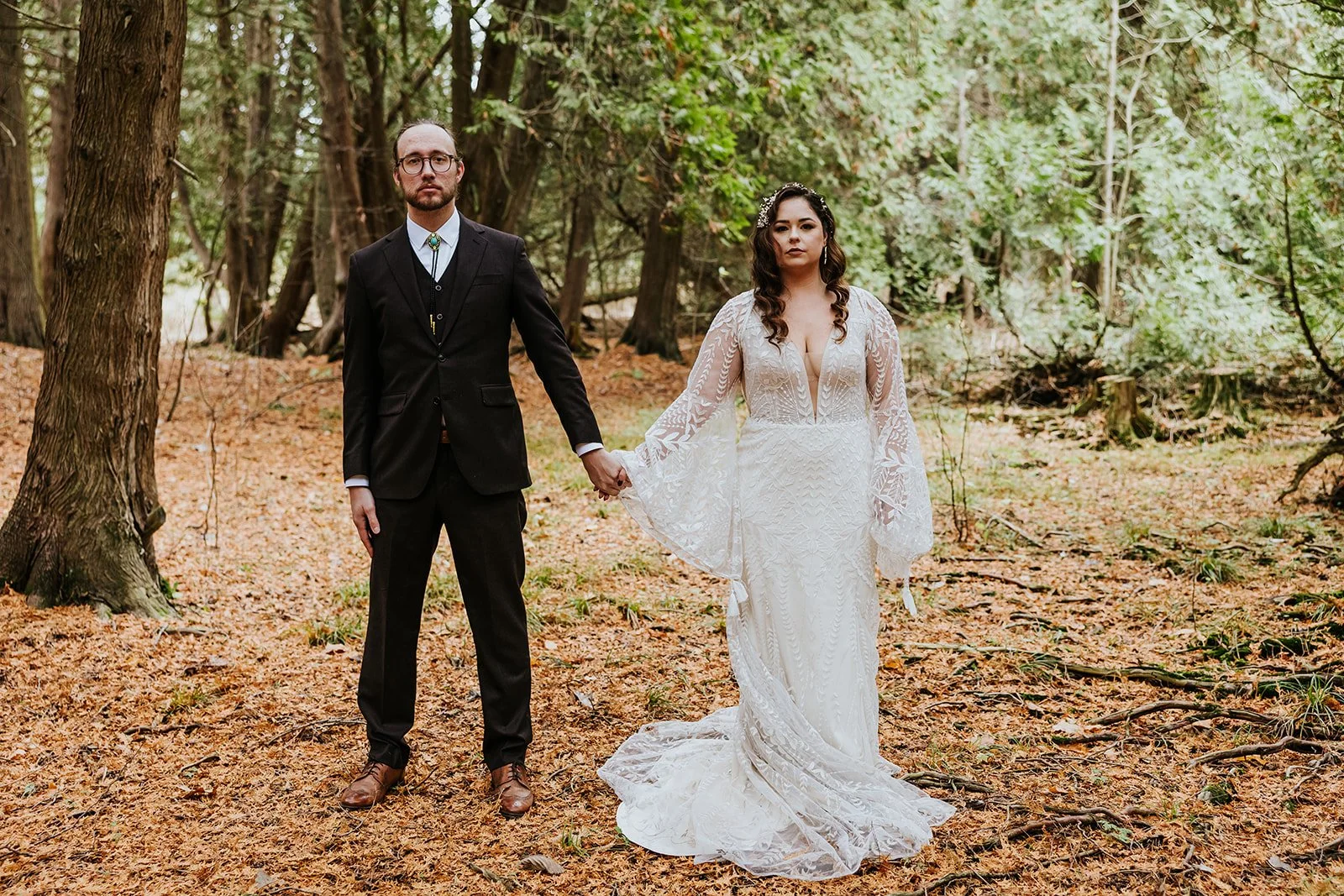 Serious bride and groom pose in the woods at Erin Estate photo by Fedora Media.jpg