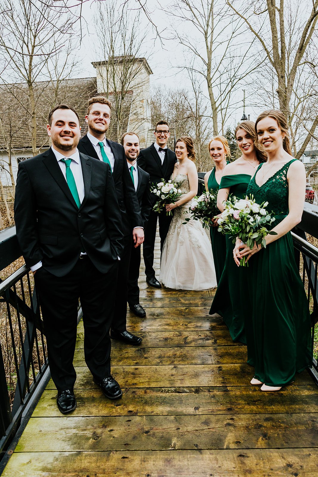 Wedding party in green and bride and groom at the Ancaster Mill photo by Fedora Media.jpg