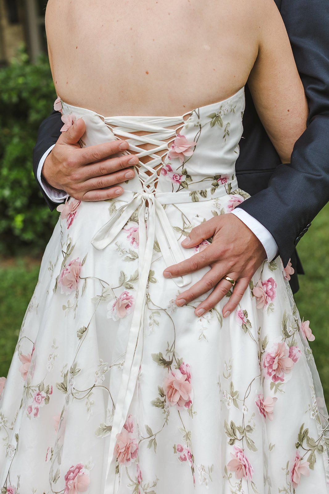 Groom Embracing Bride ith Wedding Ring  Fedora Media  Backyard Wedding.jpg