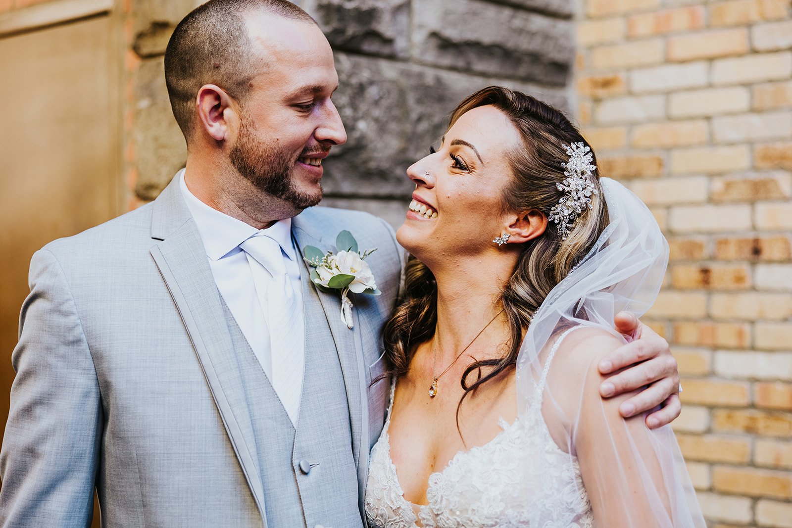 Bride and groom look at each other with love at Village Square Burlington photo by Fedora Media.jpg