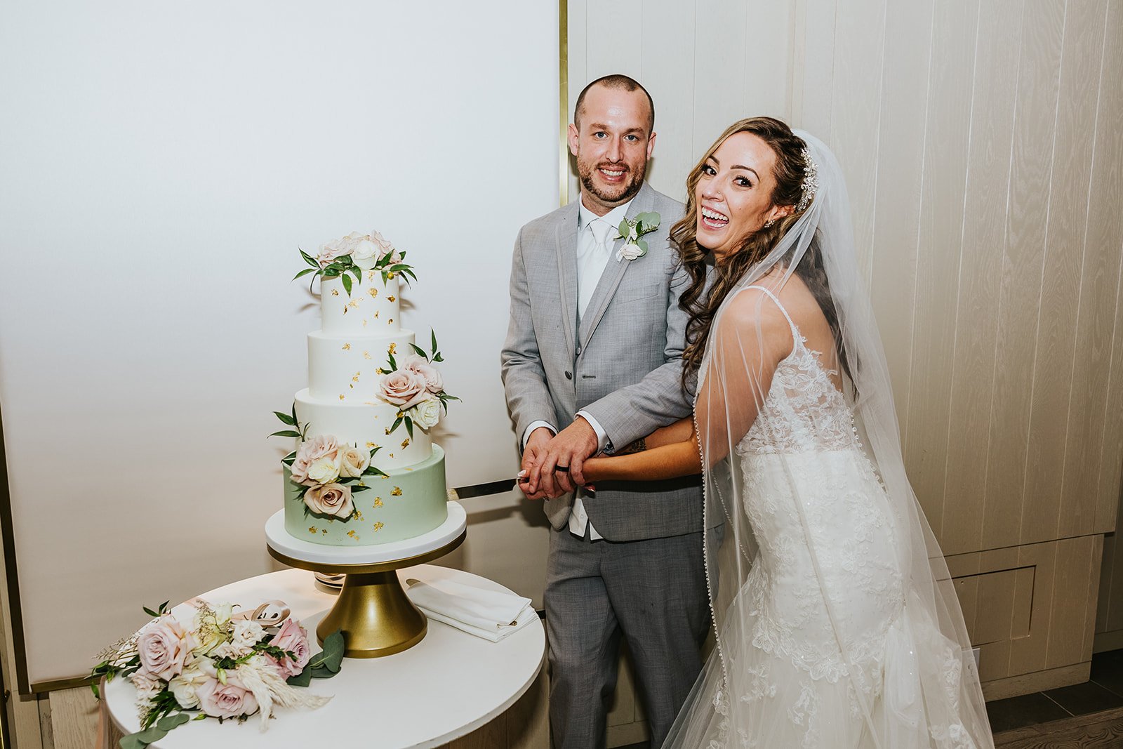 Bride and groom cut wedding cake from Sugar Suite photo by Fedora Media.jpg