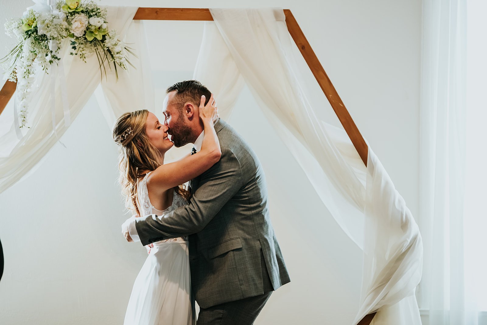 Bride and groom share a first kiss at The Spice Factory photo by Fedora Media.jpg