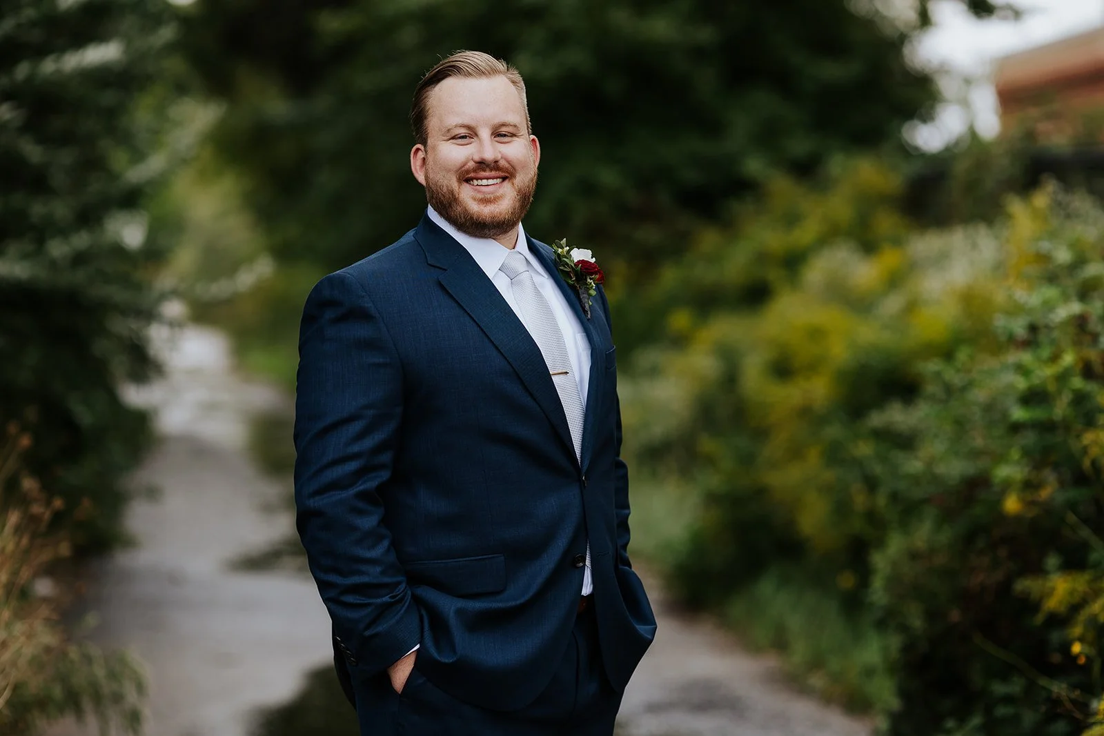 Groom in blue suit smiling photo by Fedora Media.jpg