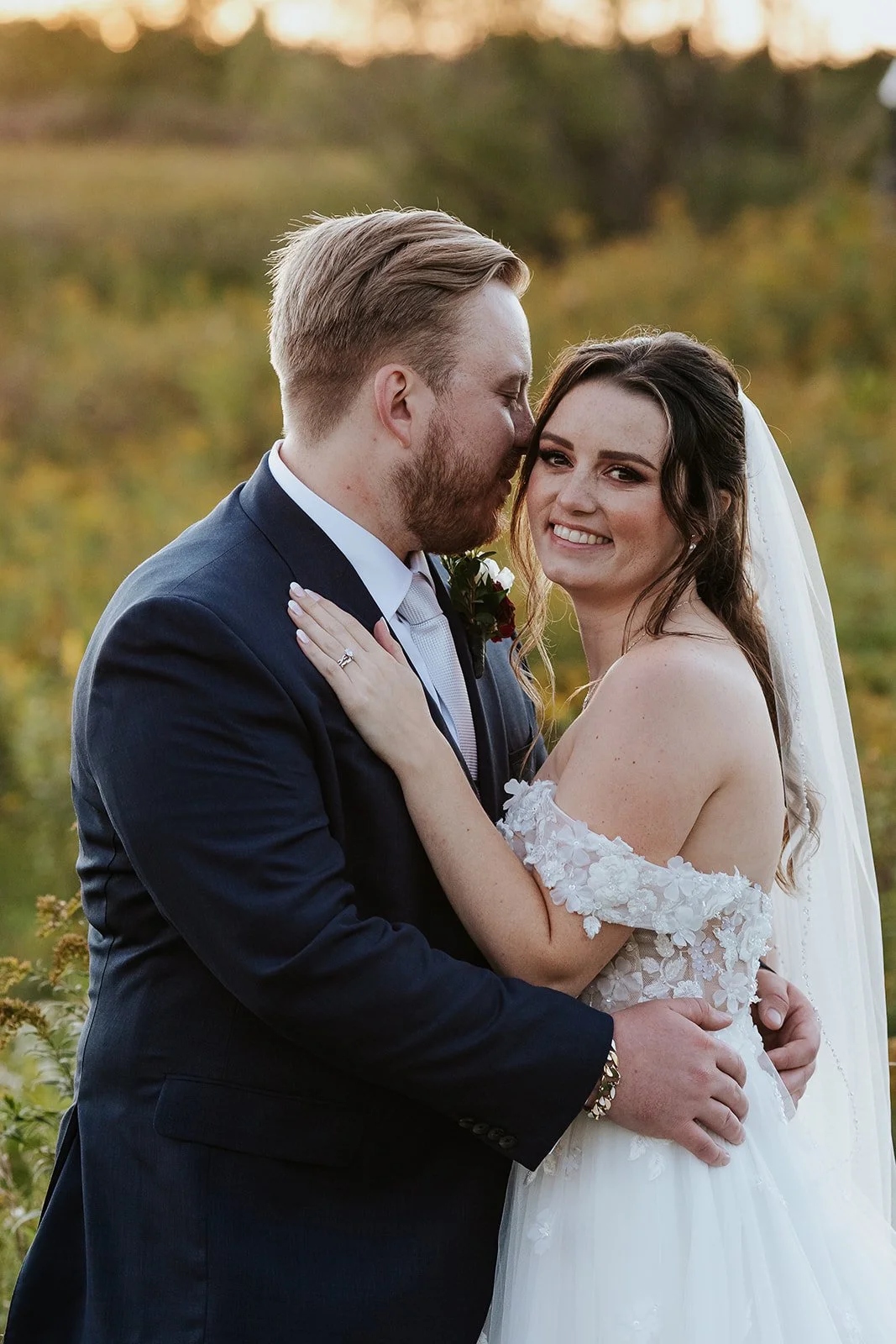 Groom hugs bride at Cambridge butterfly conservatory.jpg