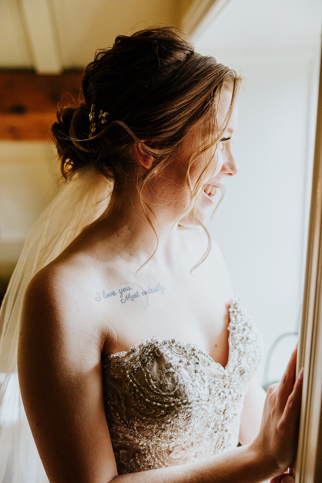 The bride looks out the window in anticipation at the Ancaster Mill photo by Fedora Media.jpg