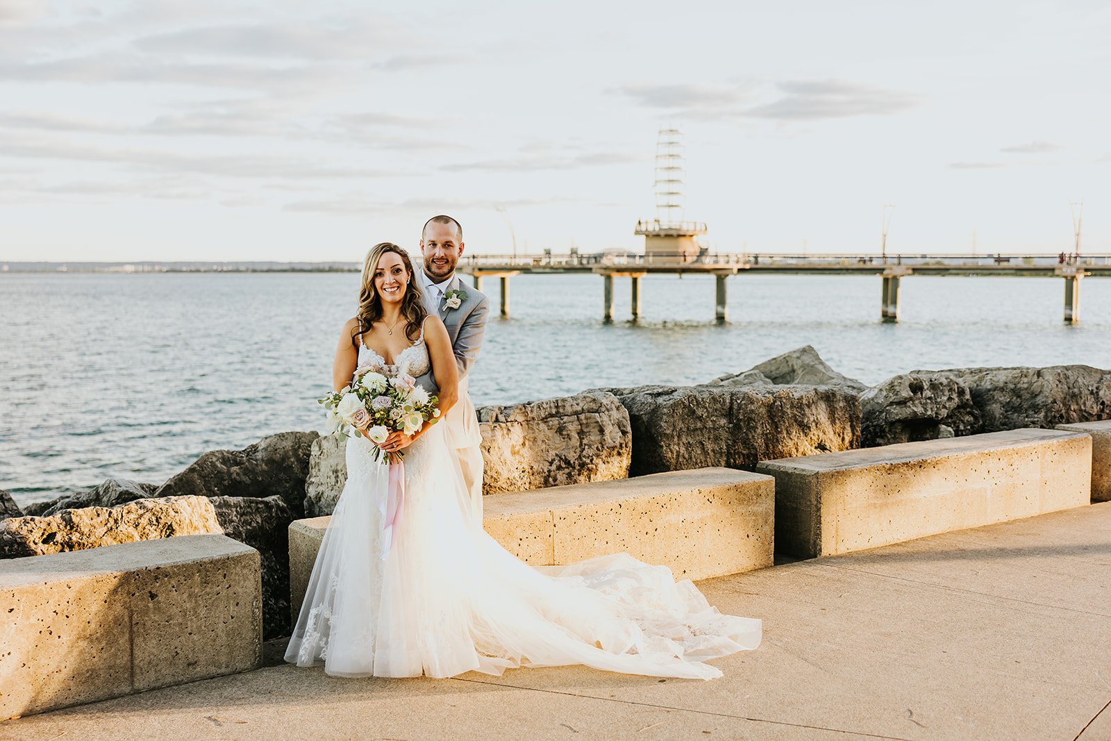 Bride and groom waterfront phtoosthoo at the Burlignton pierl Photo by Fredora Media.jpg