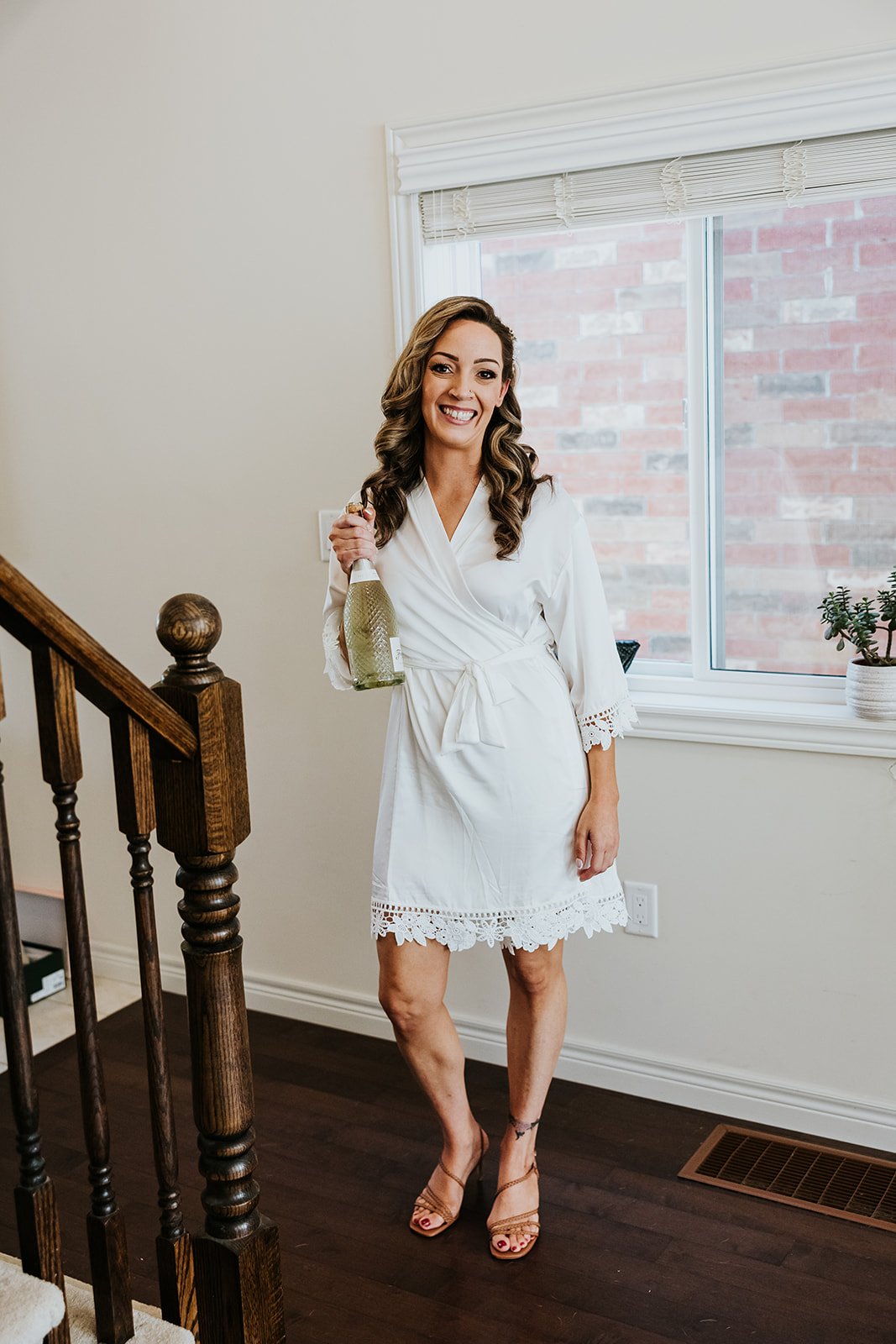 Bride with a bottle of champagne photo by Fedora Media.jpg