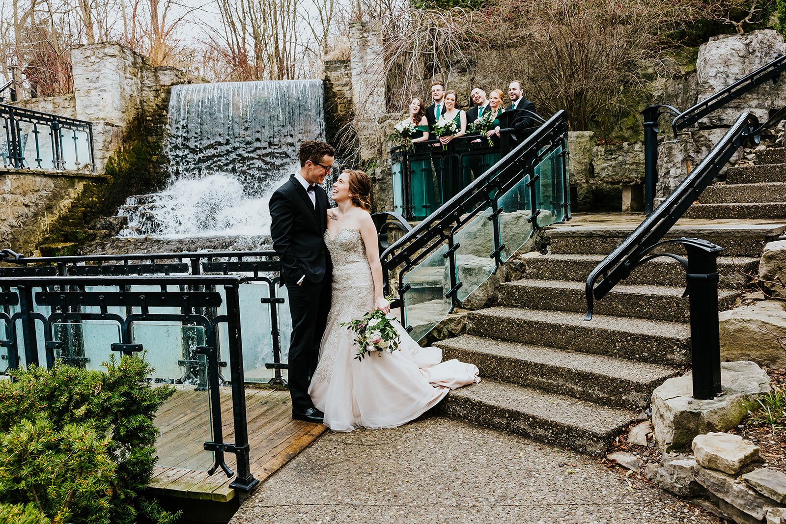 Bride and groom kiss by Ancaster mill waterfall photo by Fedora Media.jpg