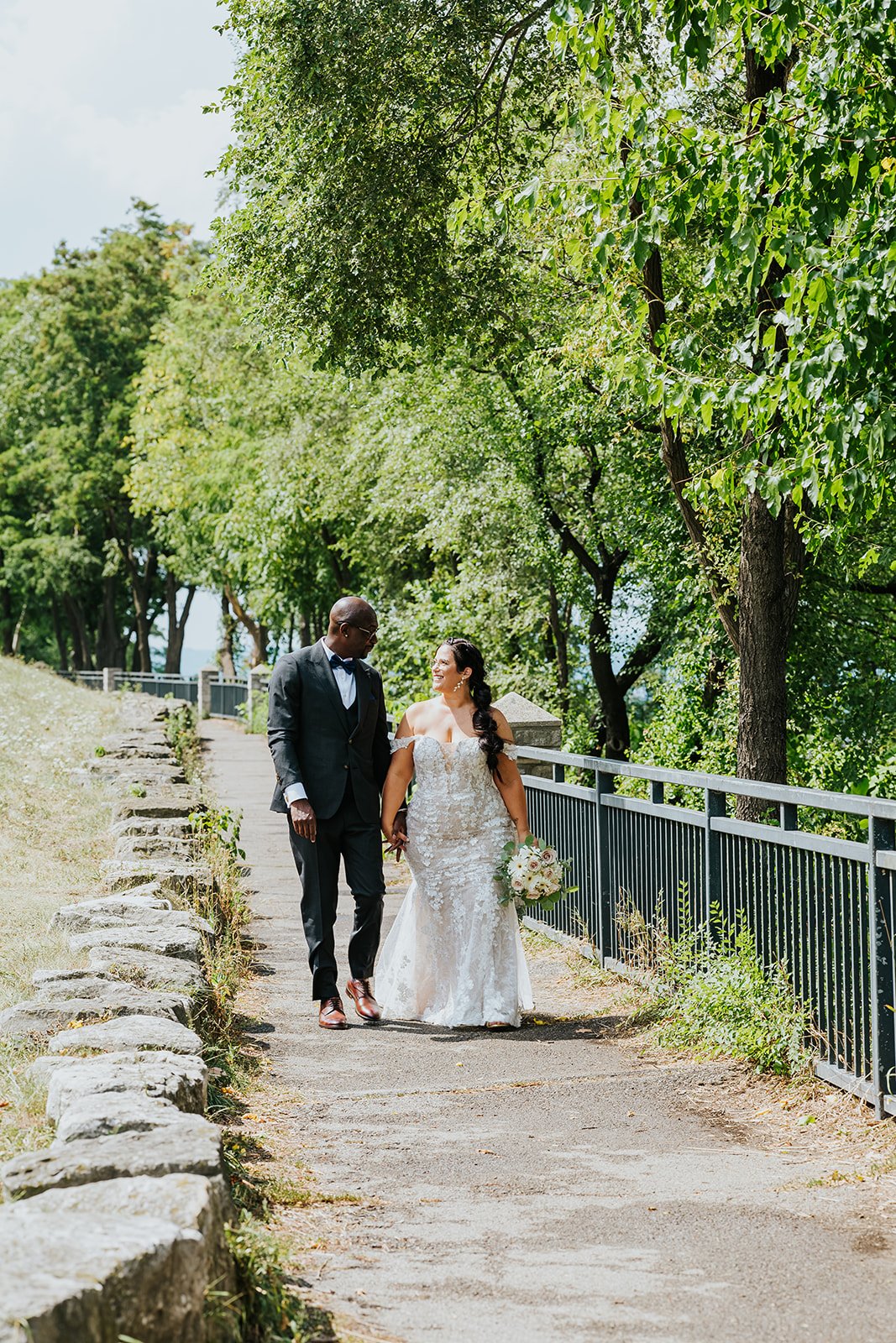 Bride and groom walking in Burlington photo by Fedora Media.jpg
