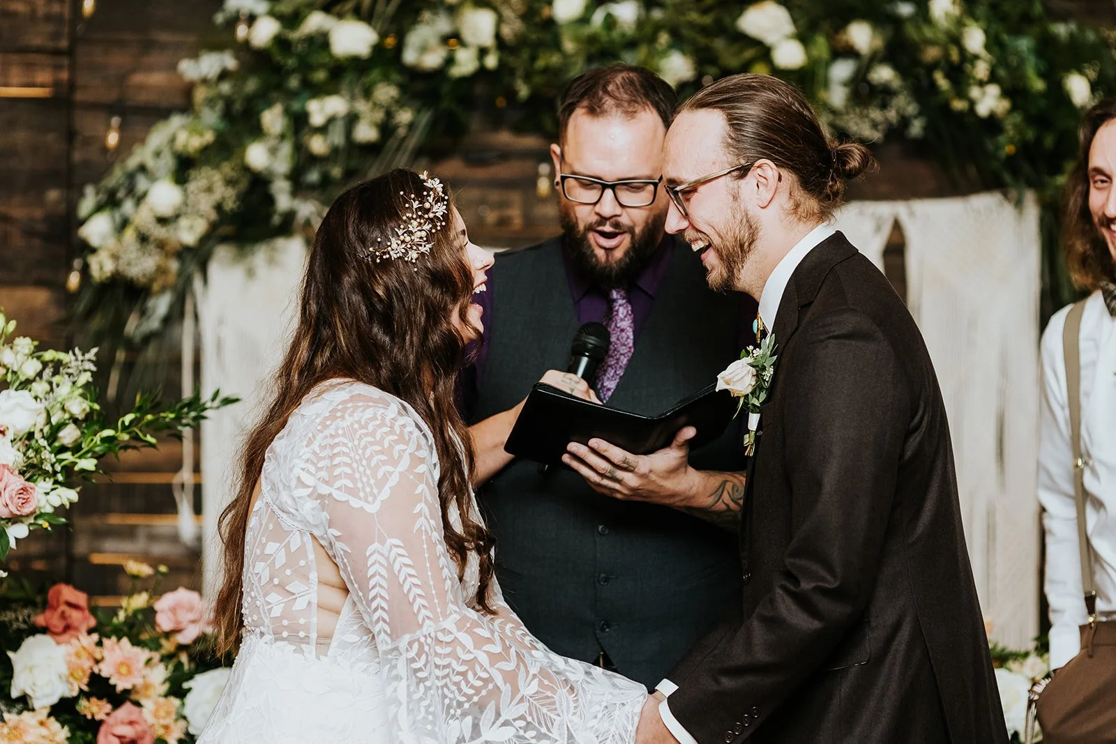 Bride and groom laugh with joy at boho wedding photo by Fedora Media.jpg