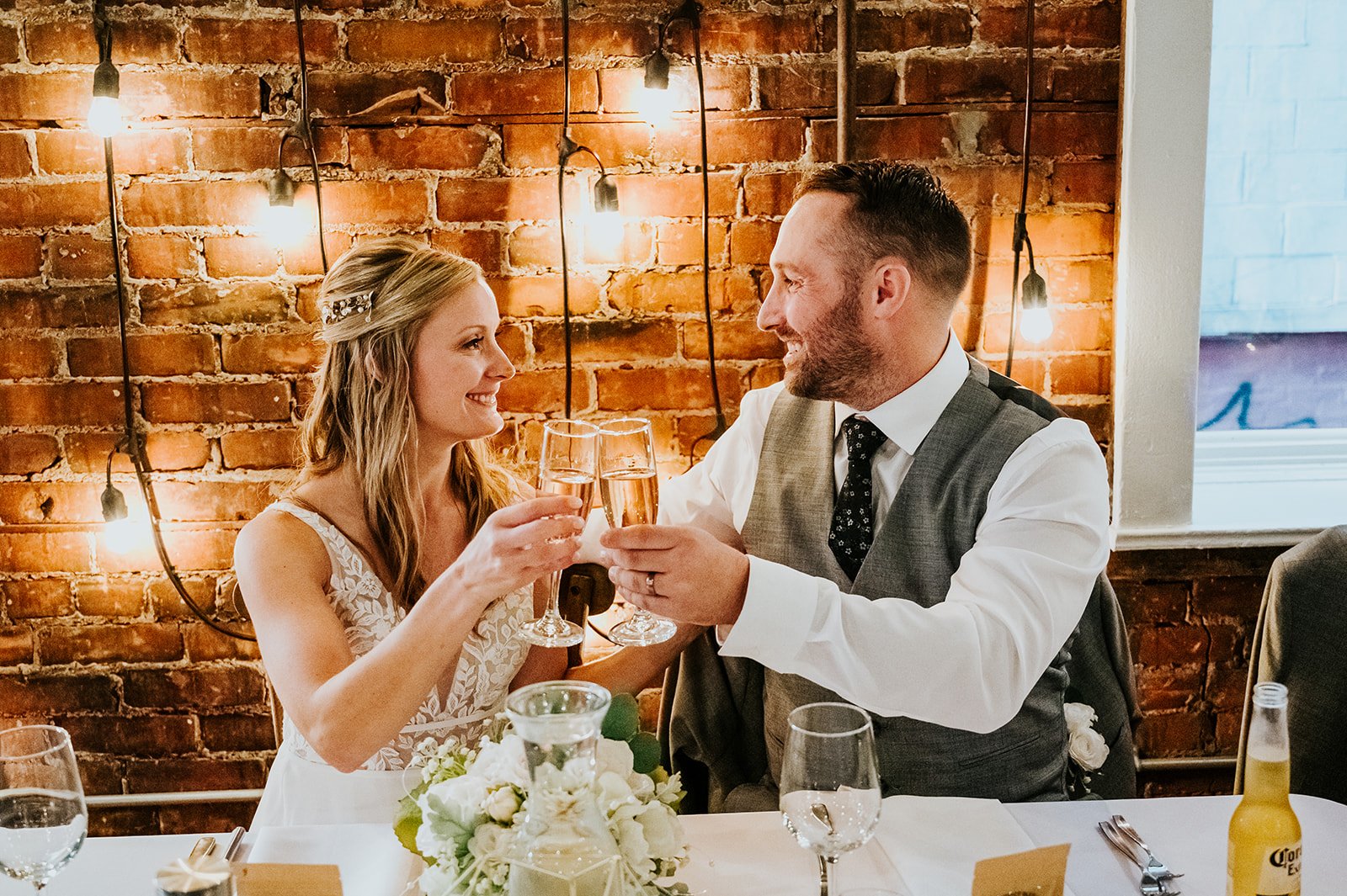 Bride and groom cheer at head table at The Spice Factory photo by Fedora Media.jpg