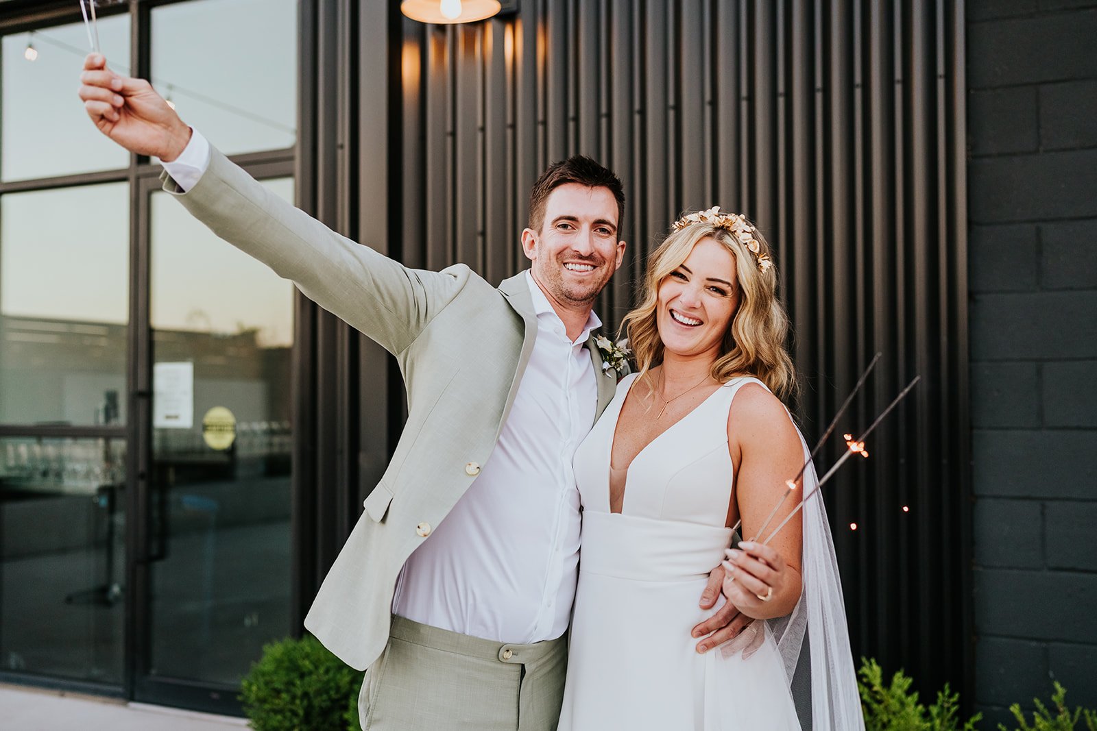 Bride and groom play with sparklers photo by Fedora Media.jpg