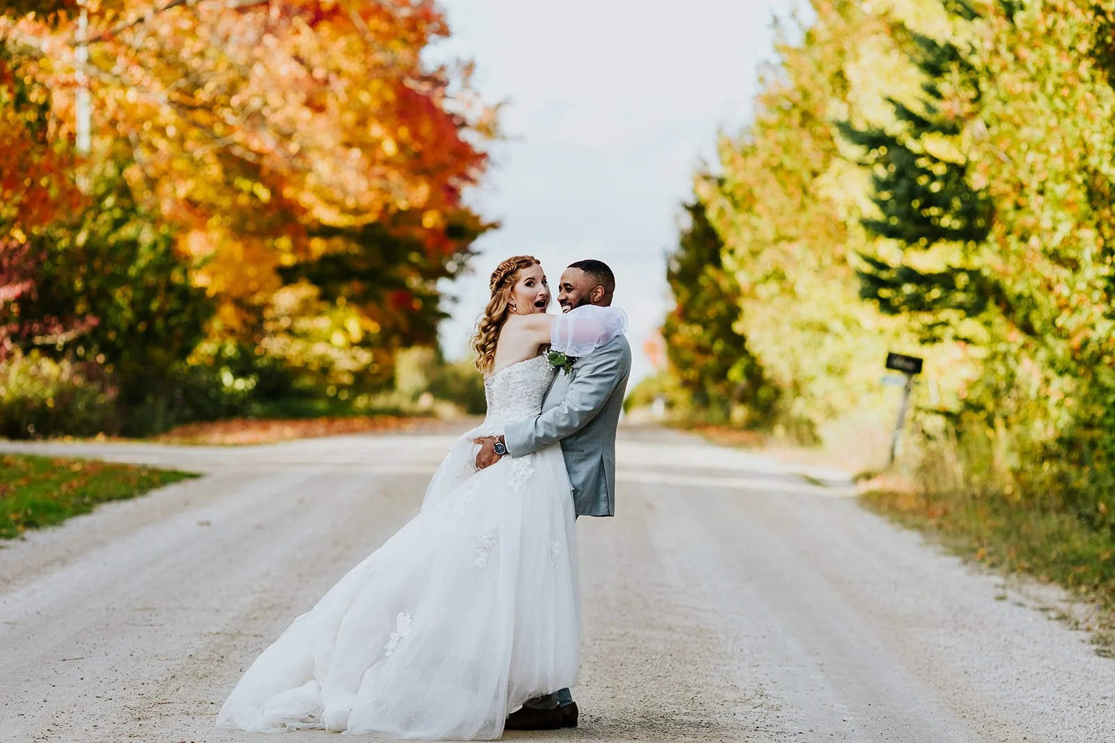 Groom surprises bride in candid moment at fall wedding photos by fedora media.jpg