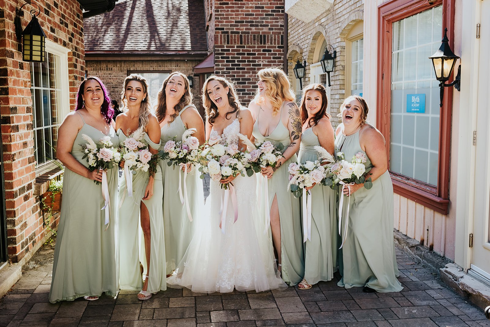 Bride and bridesmaids in sage at Village Square Burlington photo by Fedora Media.jpg
