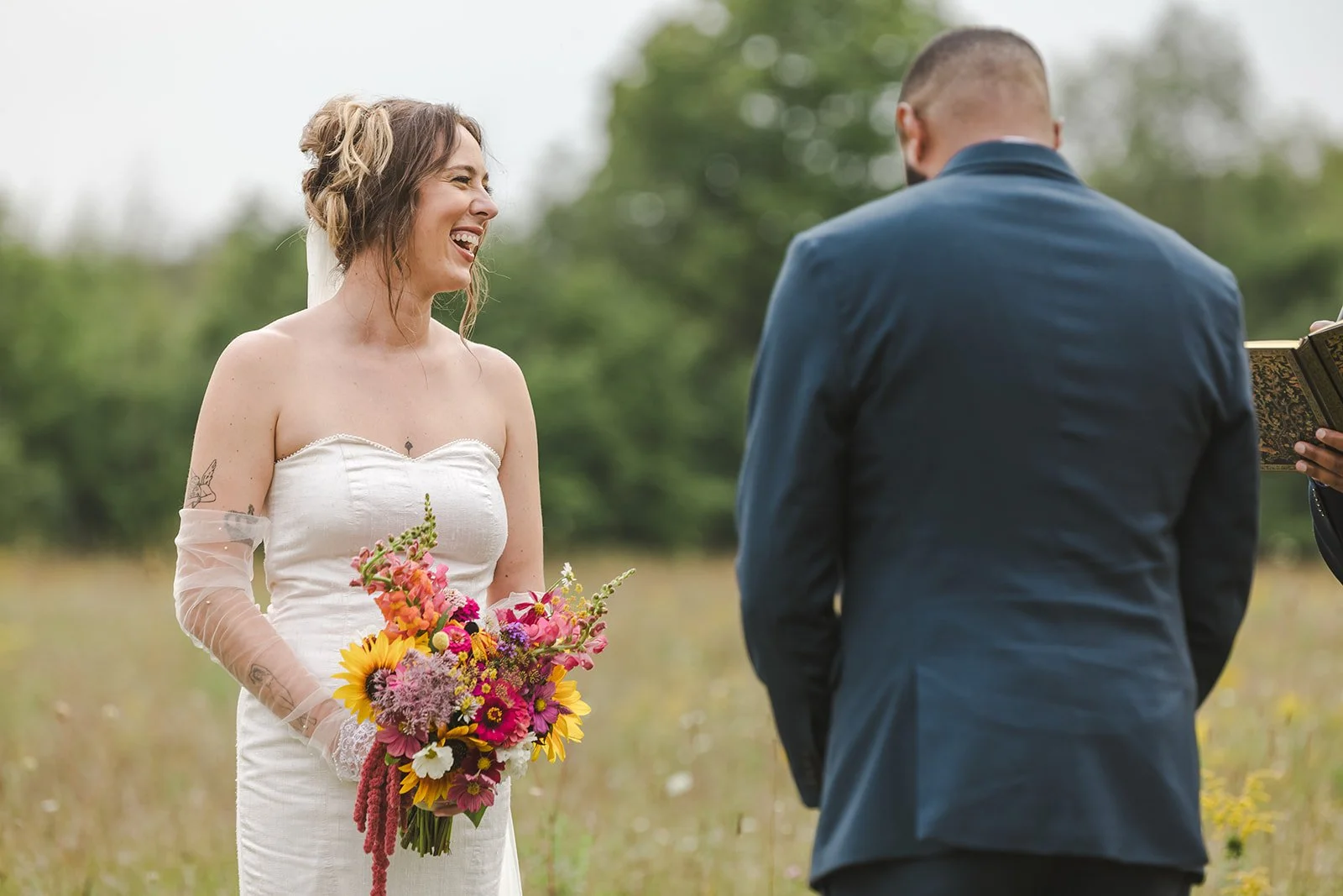 Candid Moment of Bride with Wildflower Bouquet  Fedora Media  Backyard Wedding.jpg