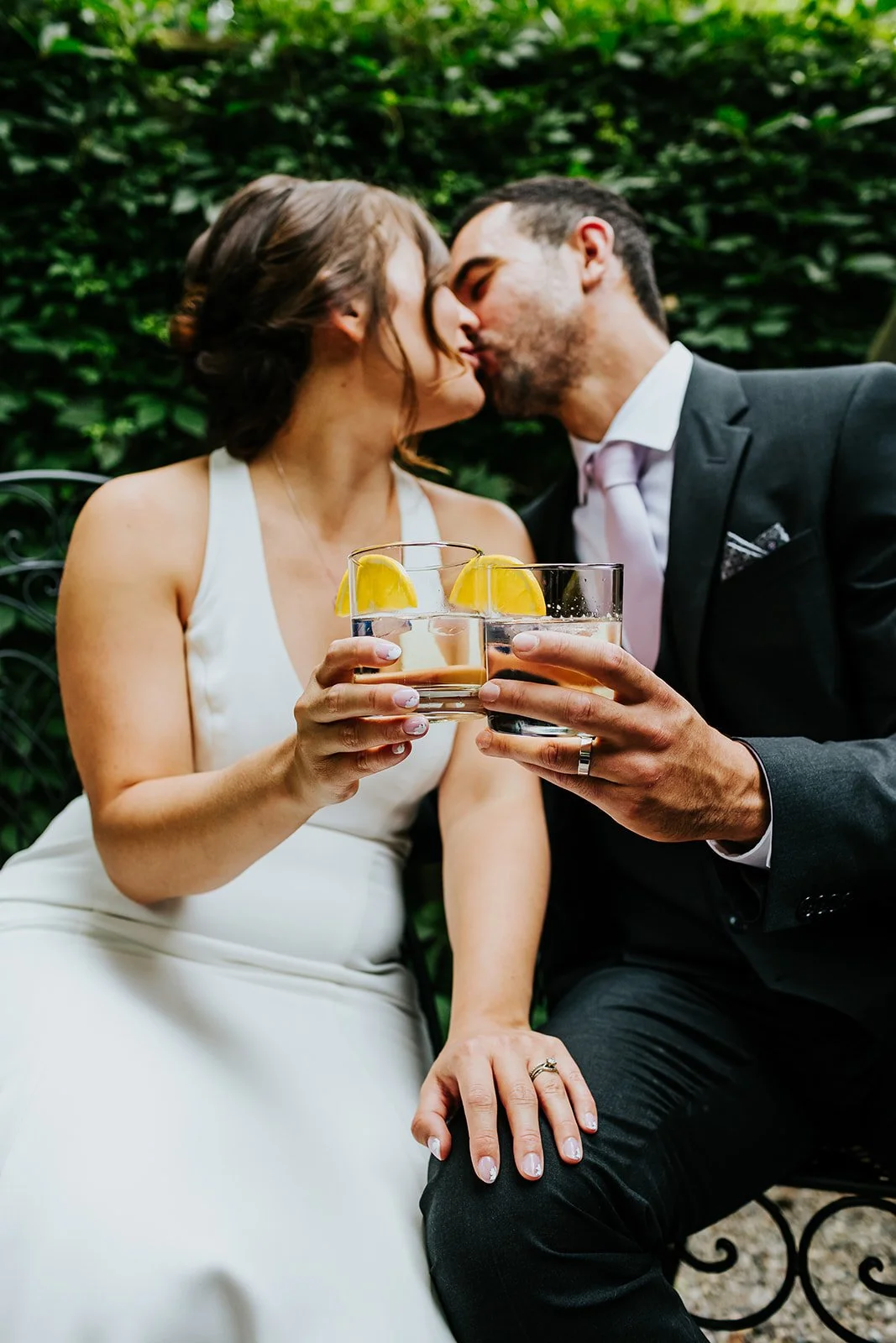 Bride and groom cheers glasses photo by Fedora Media.jpg