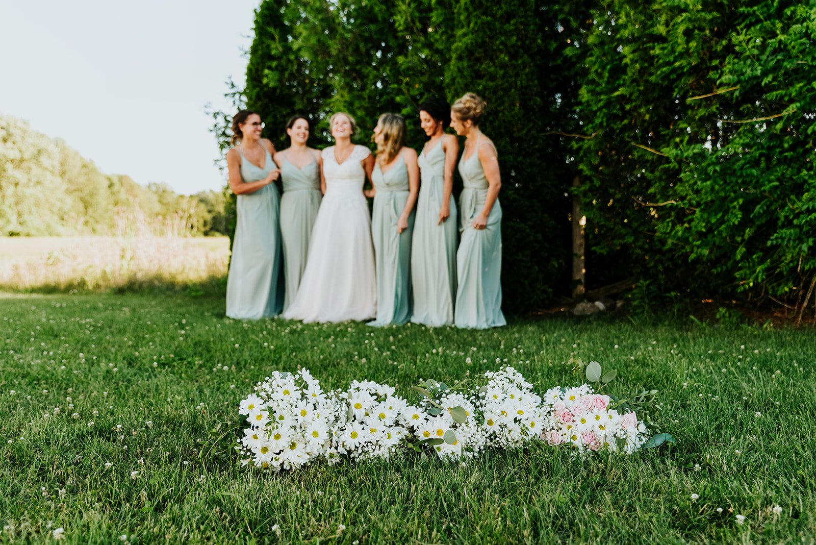Bride and bridesmaids showcase flowers photo by Fedora Media.jpg