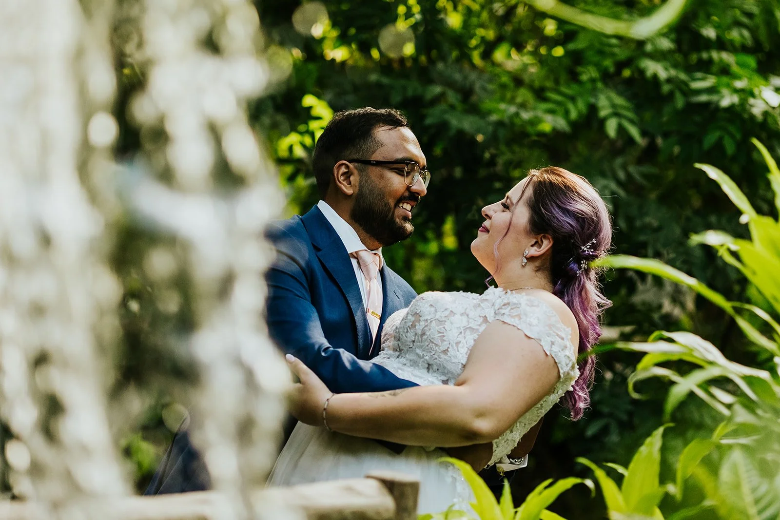 Groom dips bride under waterfall photo by Fedora Media.jpg