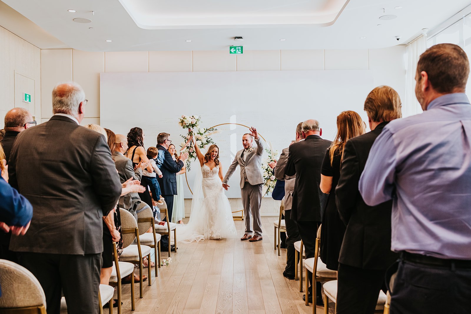 Bride and groom celebrate down the aisle at Pearle Hotel and Spa photo by Fedora Media.jpg