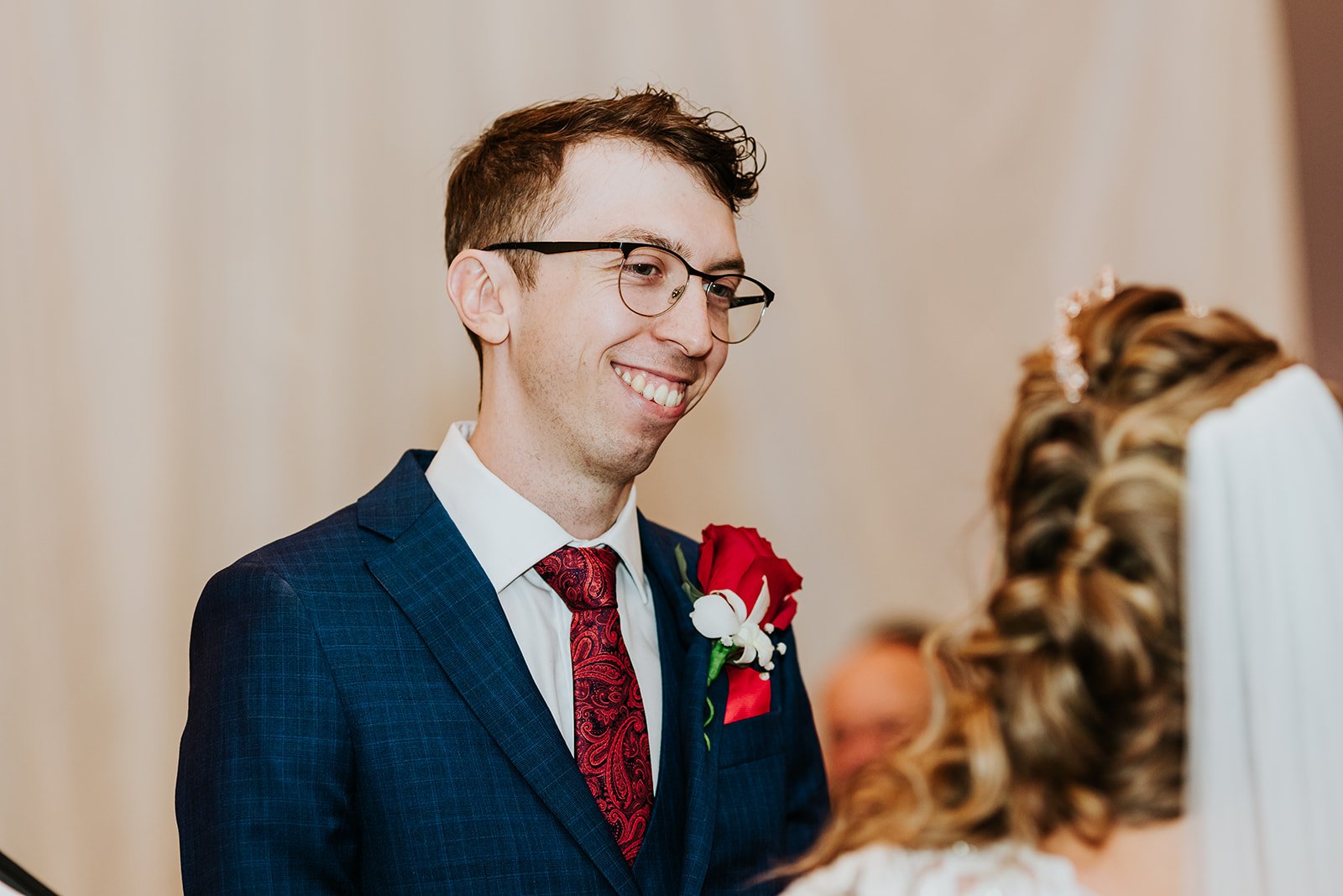 Groom looks lovingly at the bride during a wedding photo by Fedora Media.jpg