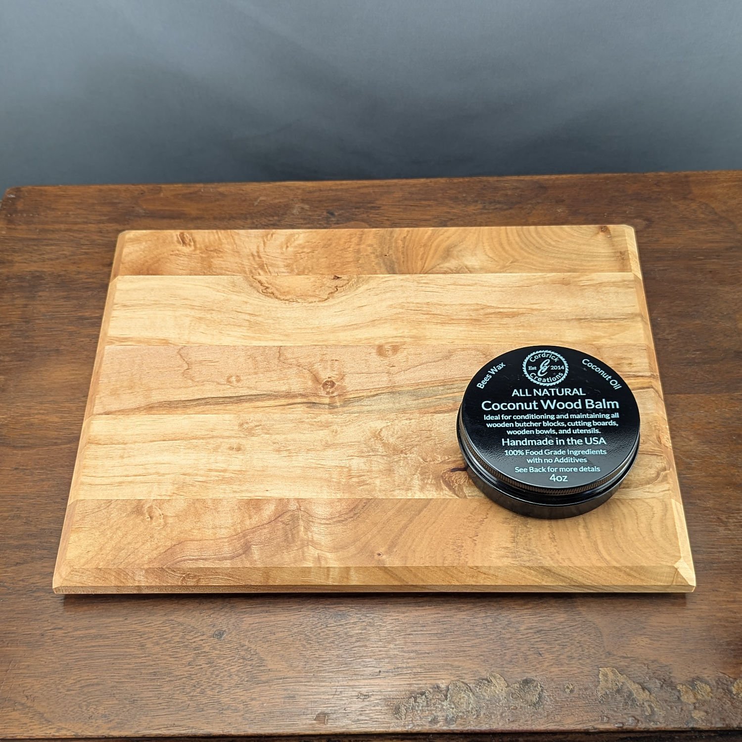 Coconut Wood Balm in tin on a wooden surface