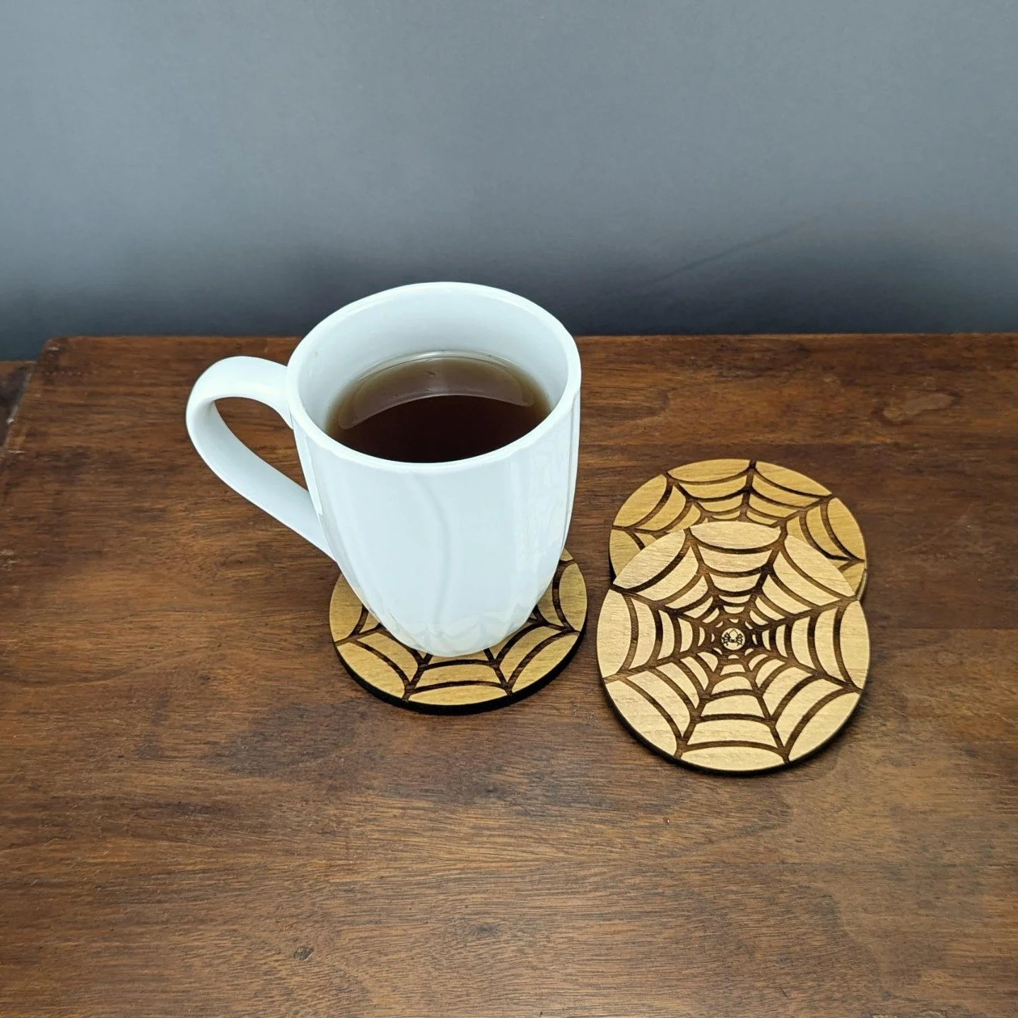 🕸️ Step into the shadows with our Shadow Web Coasters from the Webworks Collection. Handcrafted from solid Black Locust wood, laser-engraved with a spiderweb design, and backed with cork &mdash; they&rsquo;re equal parts gothic charm and everyday fu